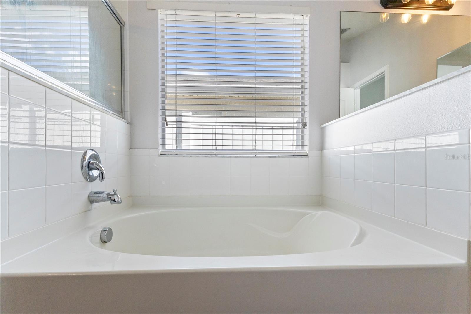A large soaking tub with a window to the world!