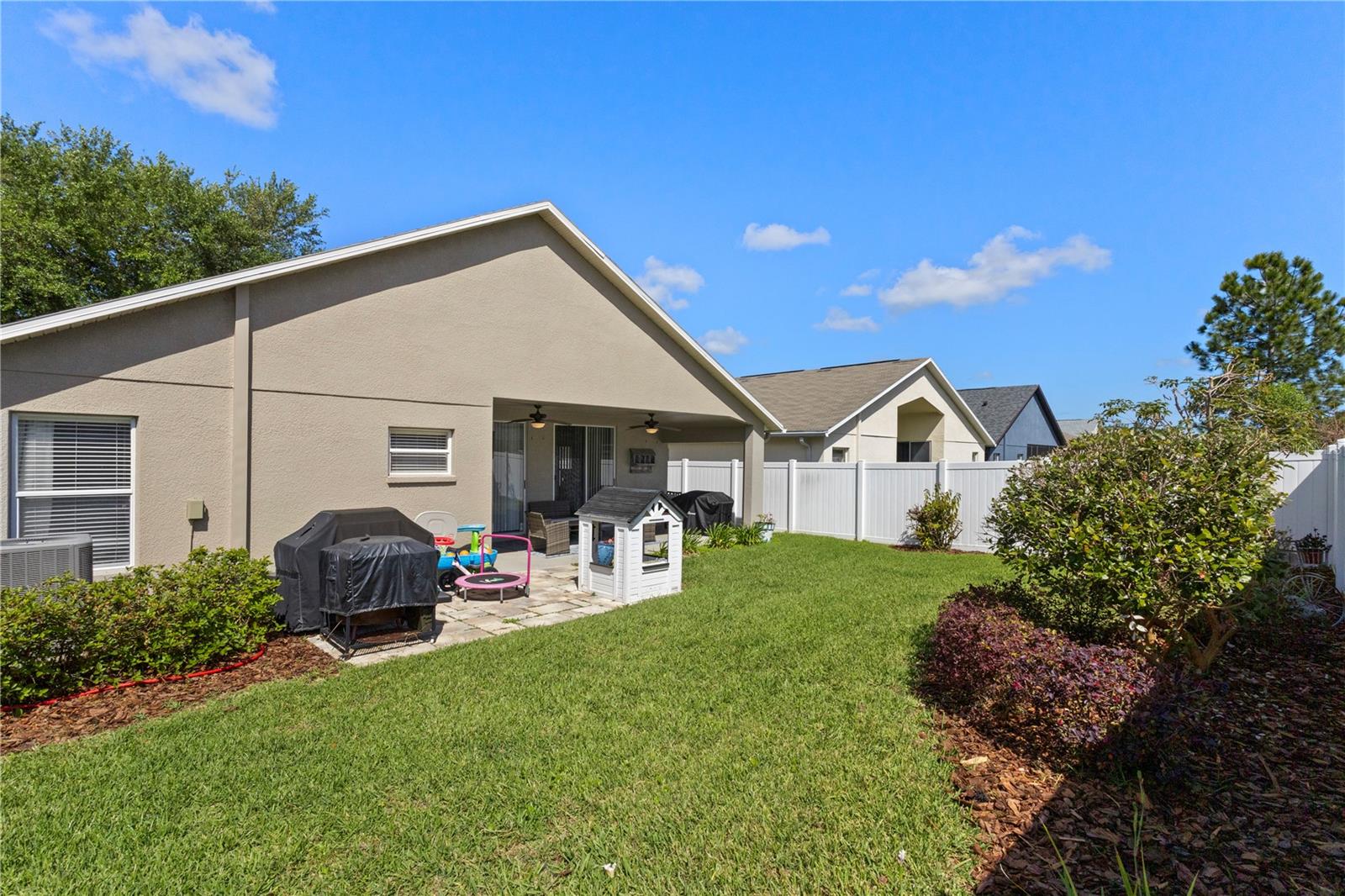 The lush back yard with an extended paver patio is ready for gatherings!