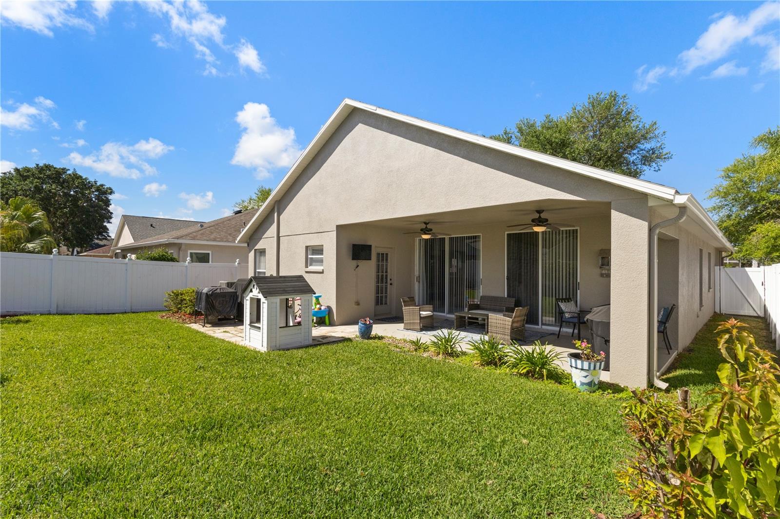 The large covered lanai features space for both outdoor living and dining and has dual ceiling fans for the summer months.