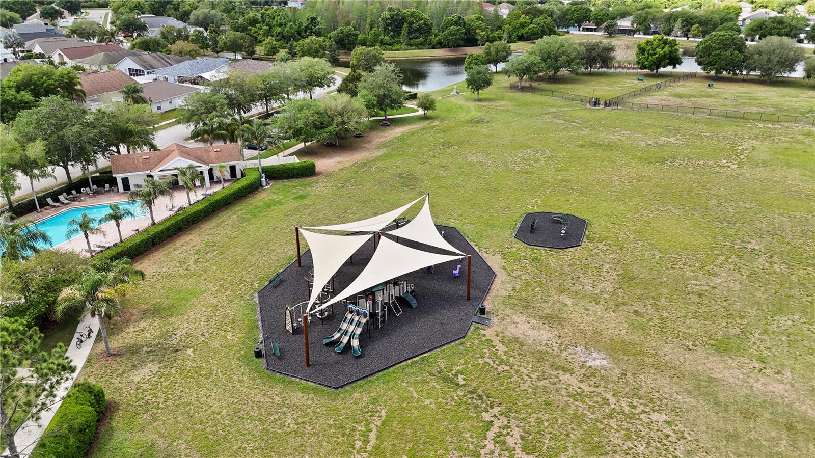 The communitey features a covered playground for kids fun along with the community pool and large grounds.