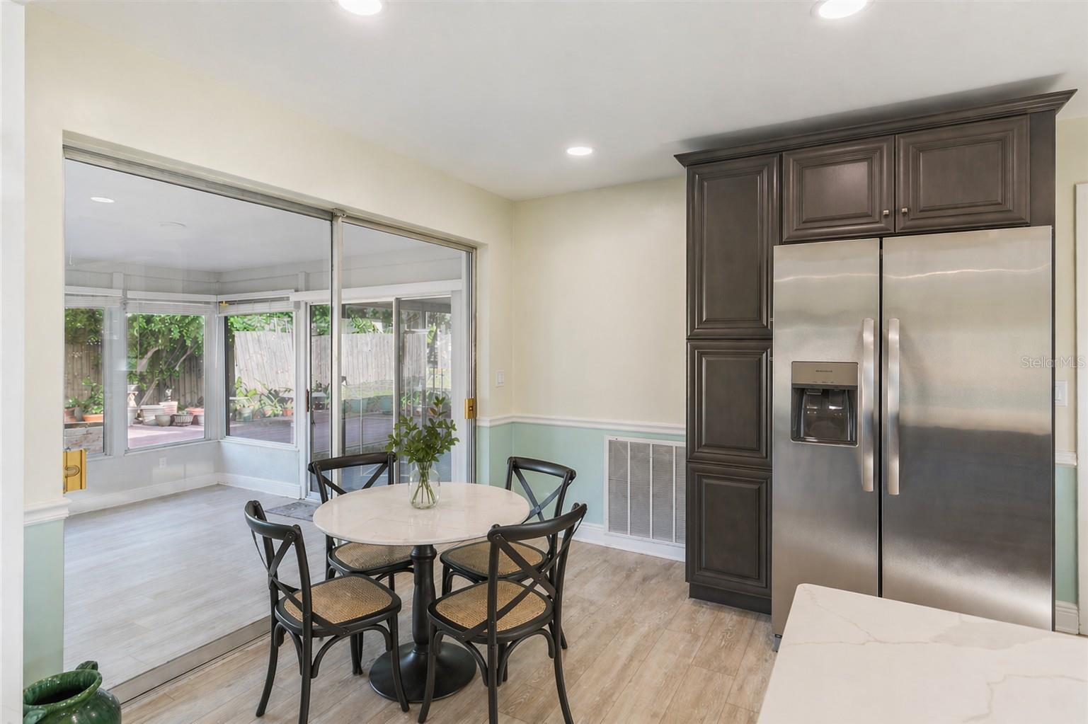 AI enhanced photo. Plenty of space for a table in the kitchen, or use bar stools for extra seating at the island.