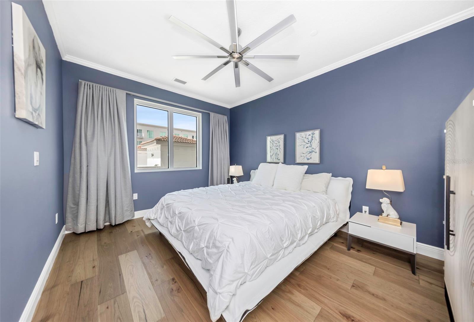 Primary bedroom with custom electronic window coverings