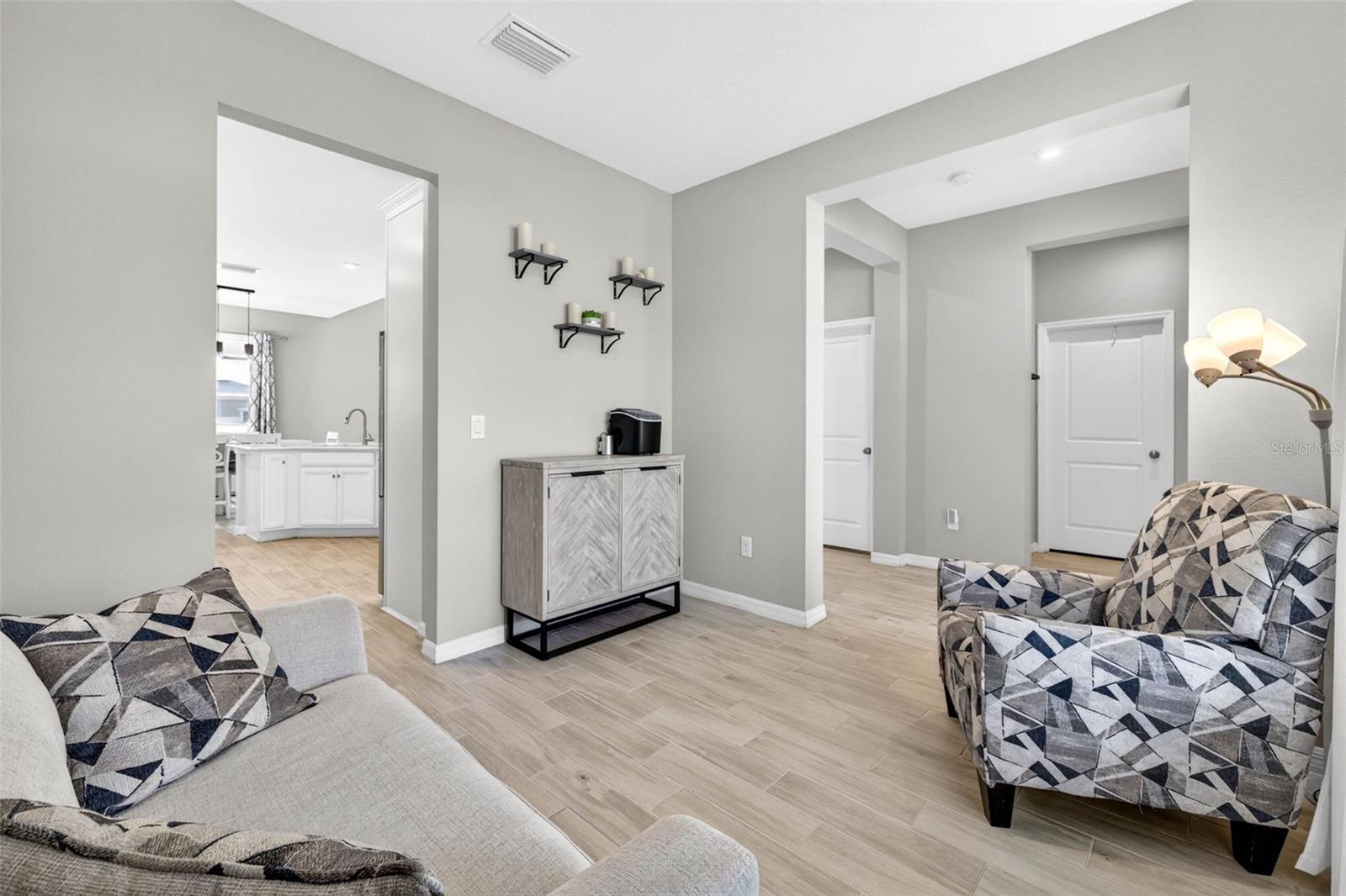 Room leads to the kitchen and the main hallway.