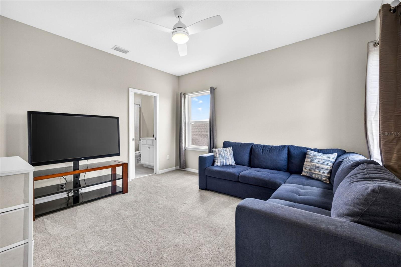 Office off of the loft serves as a second living suite with entryway to a full bathroom and bedroom.