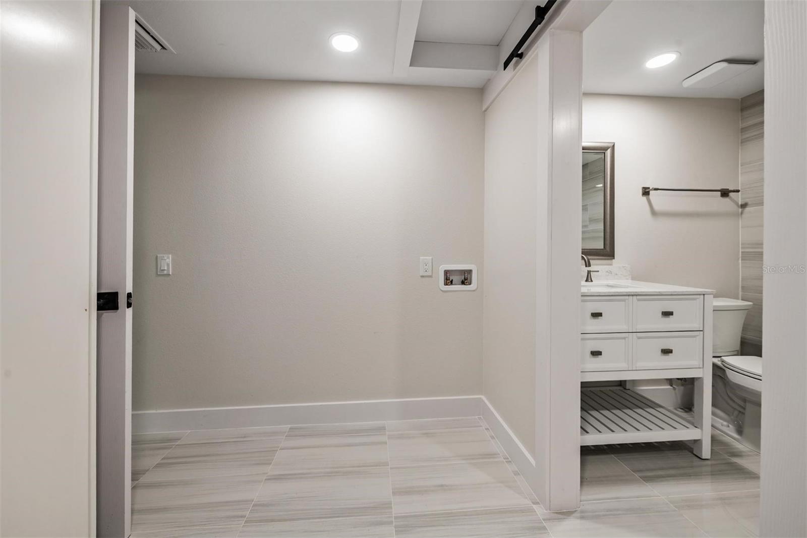 Washing machine hook ups.  Closet to the left with a full shower bath to the right.