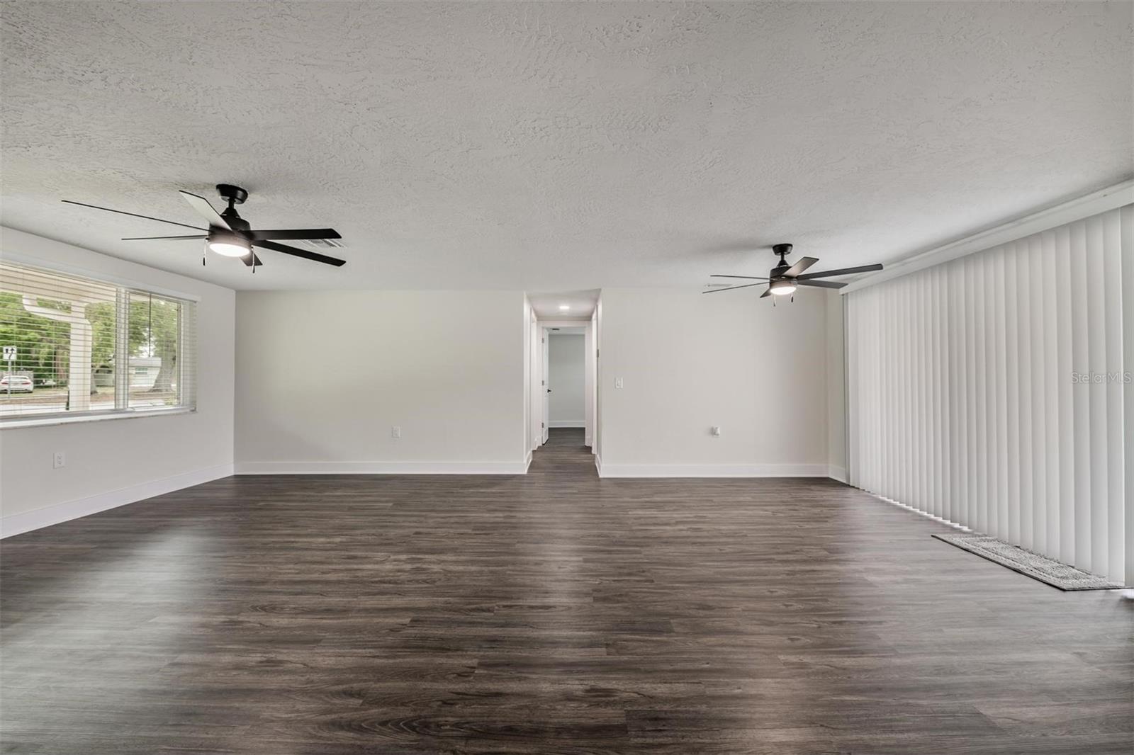 Living room / Dining area with slider to the patio.  Down the hall are 2 bedrooms and a bath.