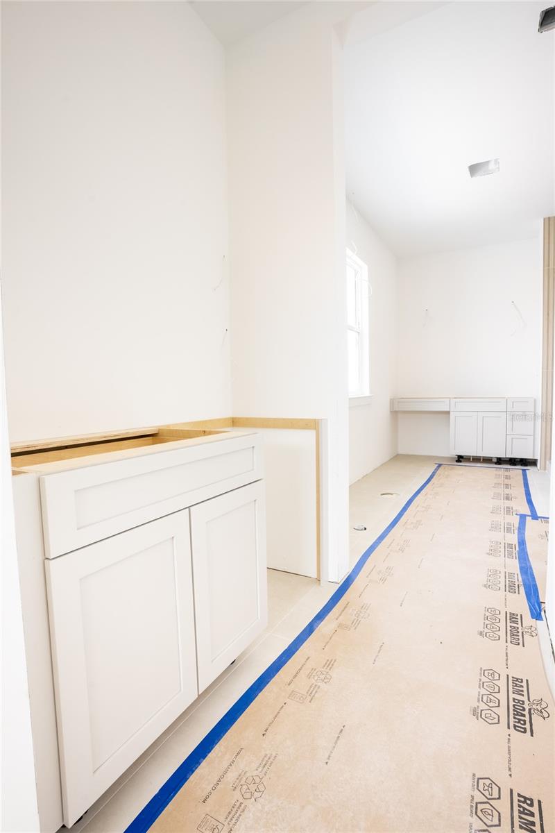 Primary bedroom with morning station and beverage refrigerator