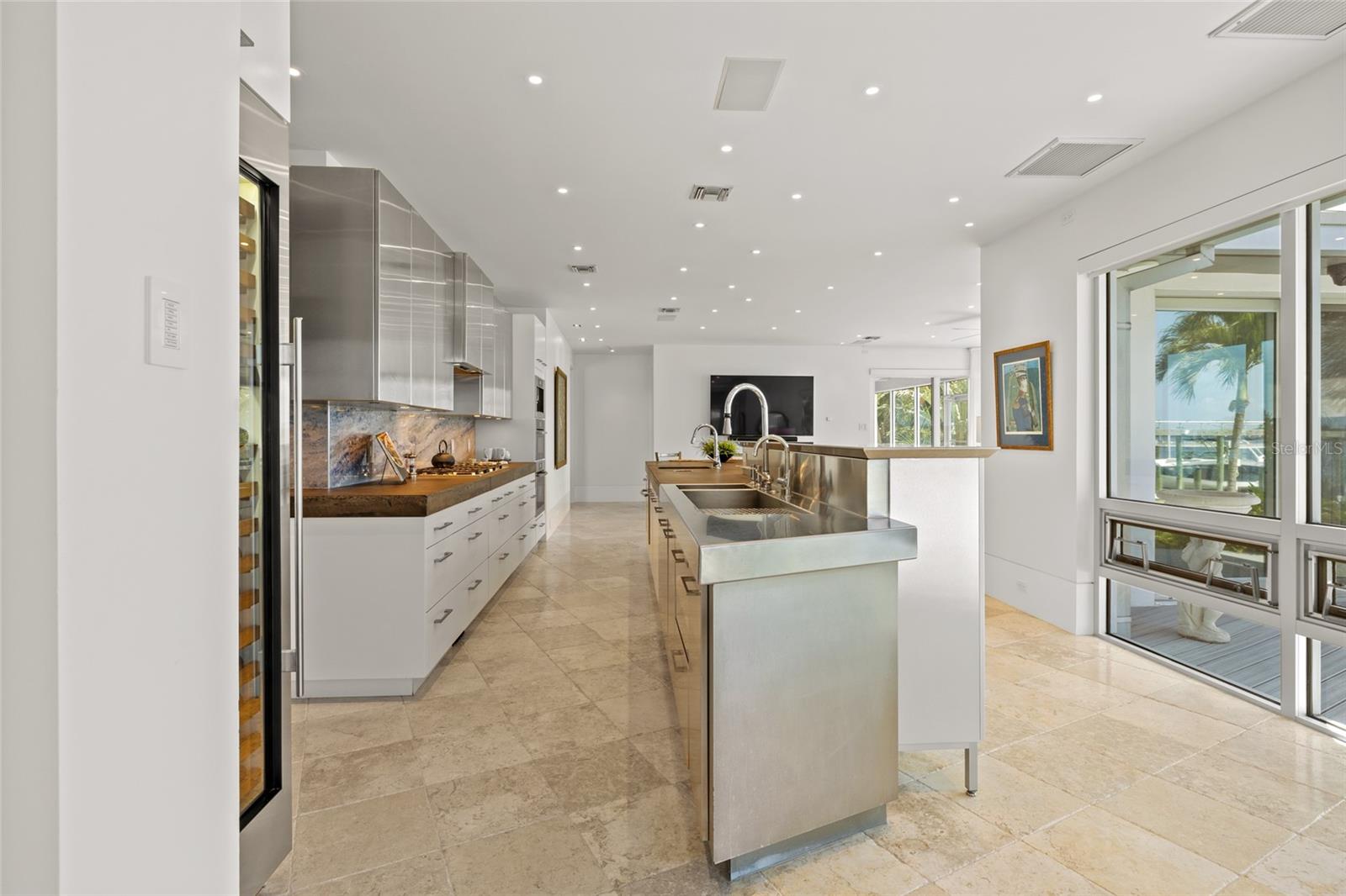 Expansive chef’s kitchen featuring stainless & concrete counters
