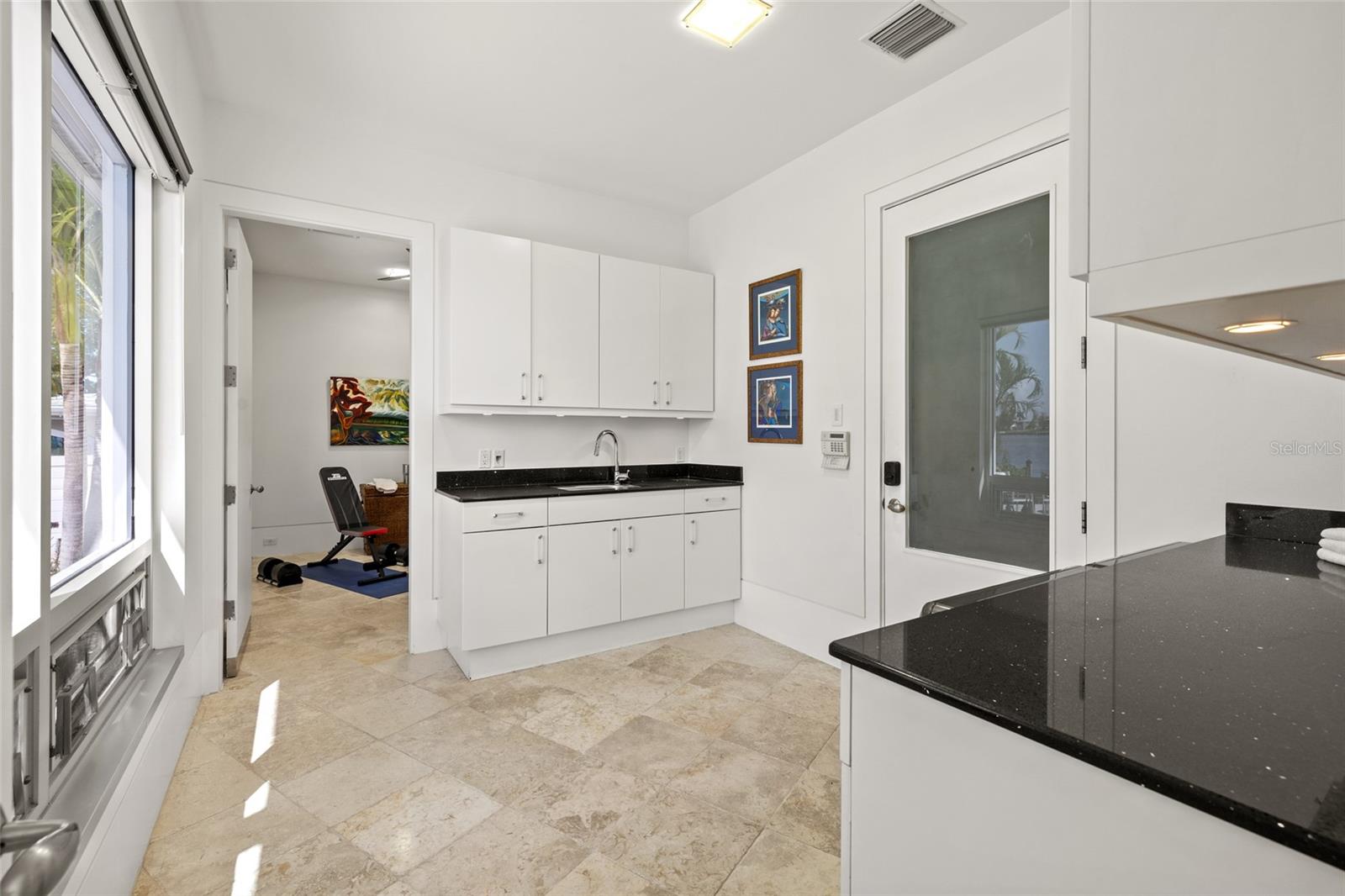 Laundry Room with Sink and folding areas. Bonus Room beyond.