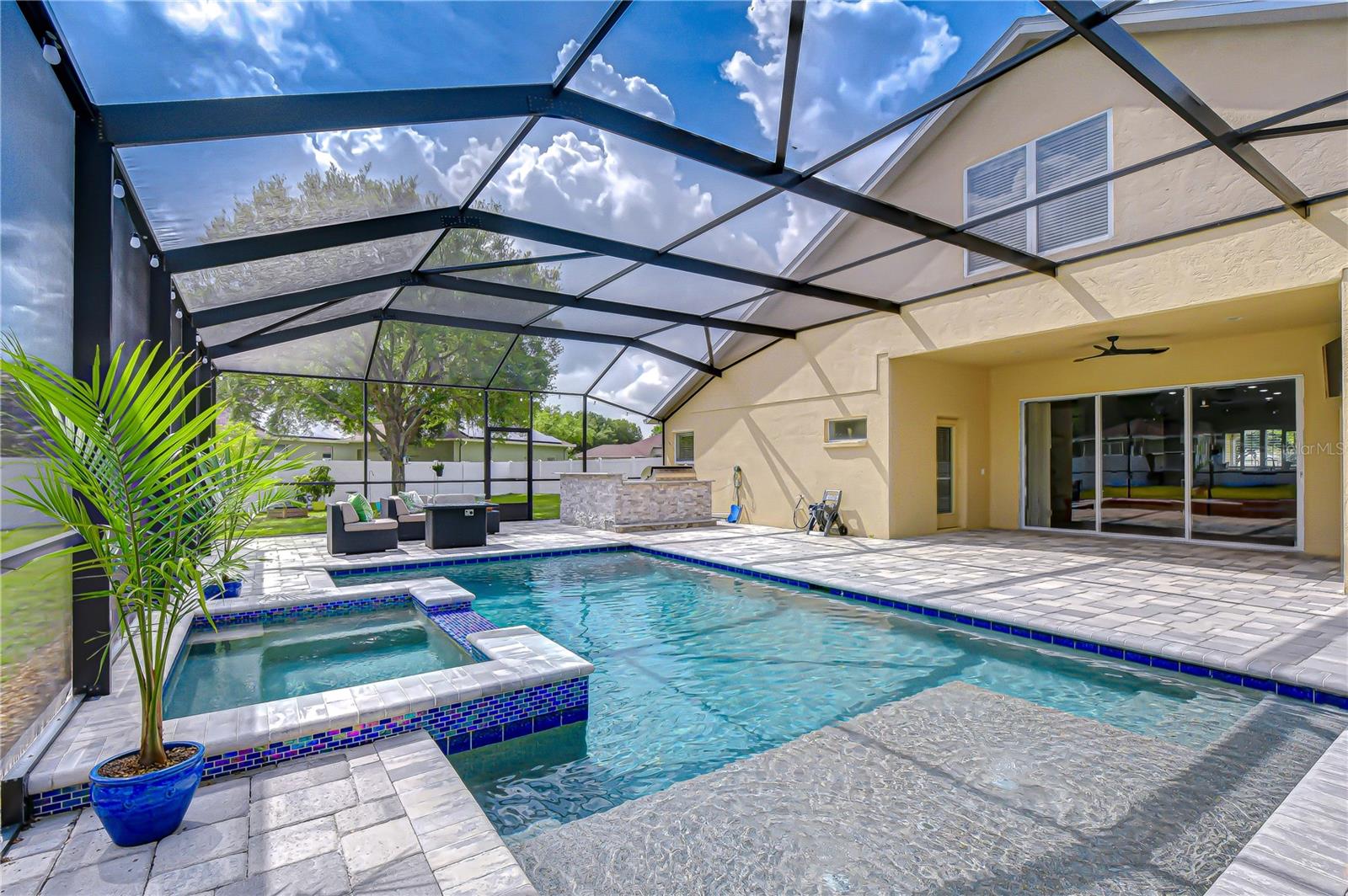 Smartphone-controlled pool automation. Heated saltwater pool and spa with Pebble Tech finish.