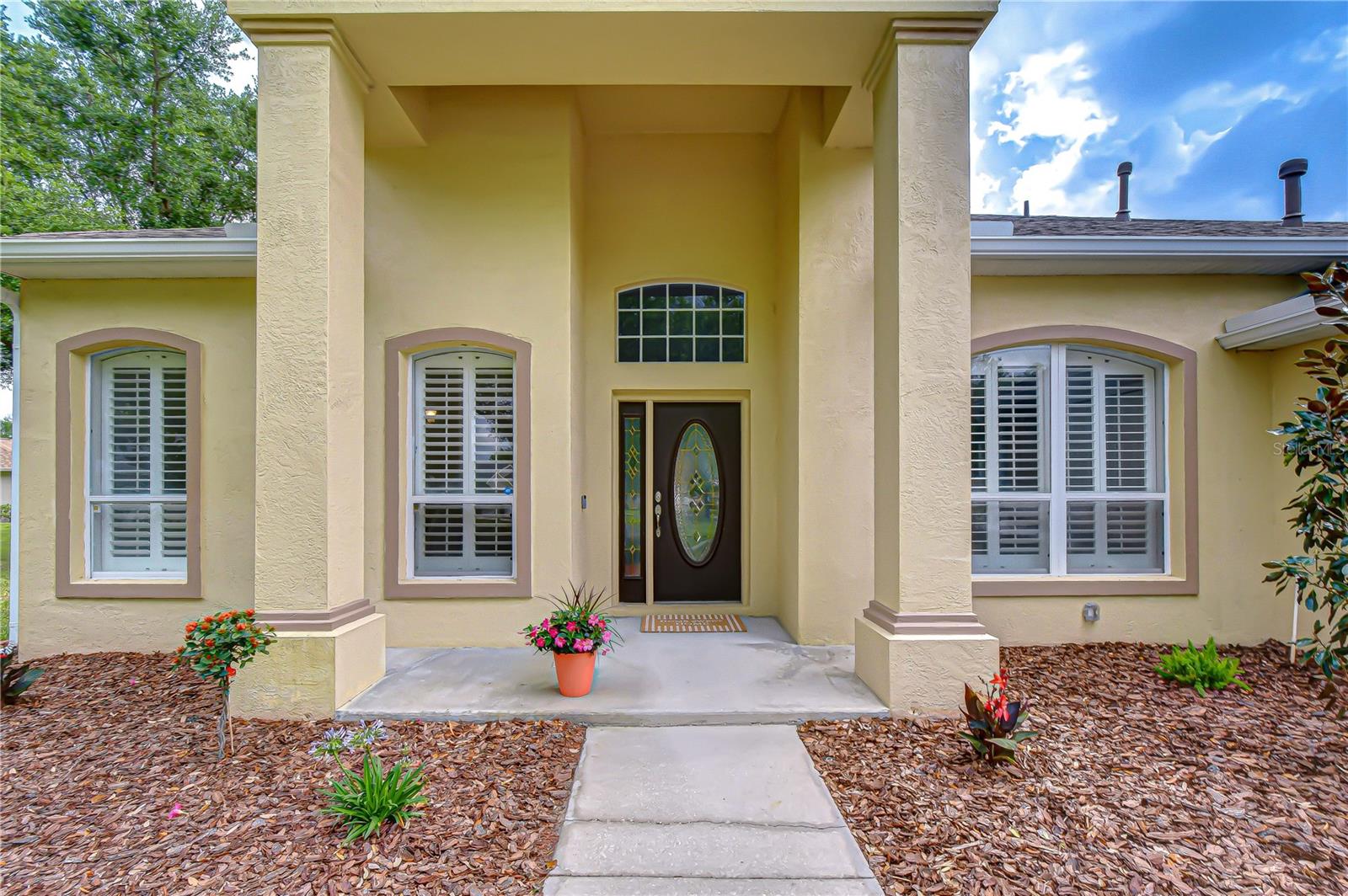 Exceptional curb appeal with lush landscaping.