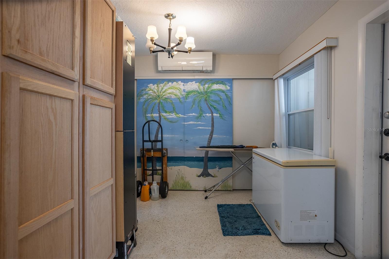 Storage area with washer and dryer just off kitchen