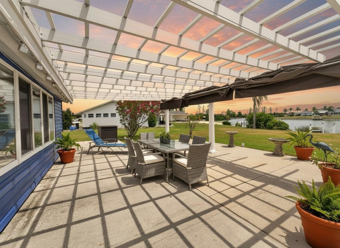 The nearly 600 sq ft pergola has a retractable ceiling, perfect for entertaining on the rainiest of nights. This photo includes virtual furnishings.