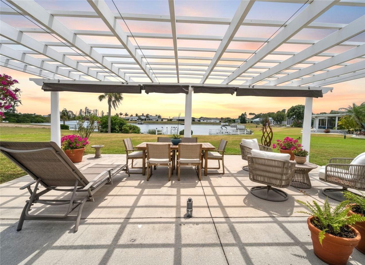 The nearly 600 sq ft pergola has a retractable ceiling, perfect for entertaining on the rainiest of nights. This photo includes virtual furnishings.