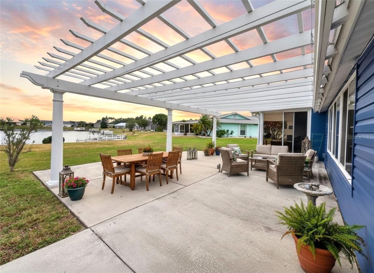 The nearly 600 sq ft pergola has a retractable ceiling, perfect for entertaining on the rainiest of nights. This photo includes virtual furnishings.