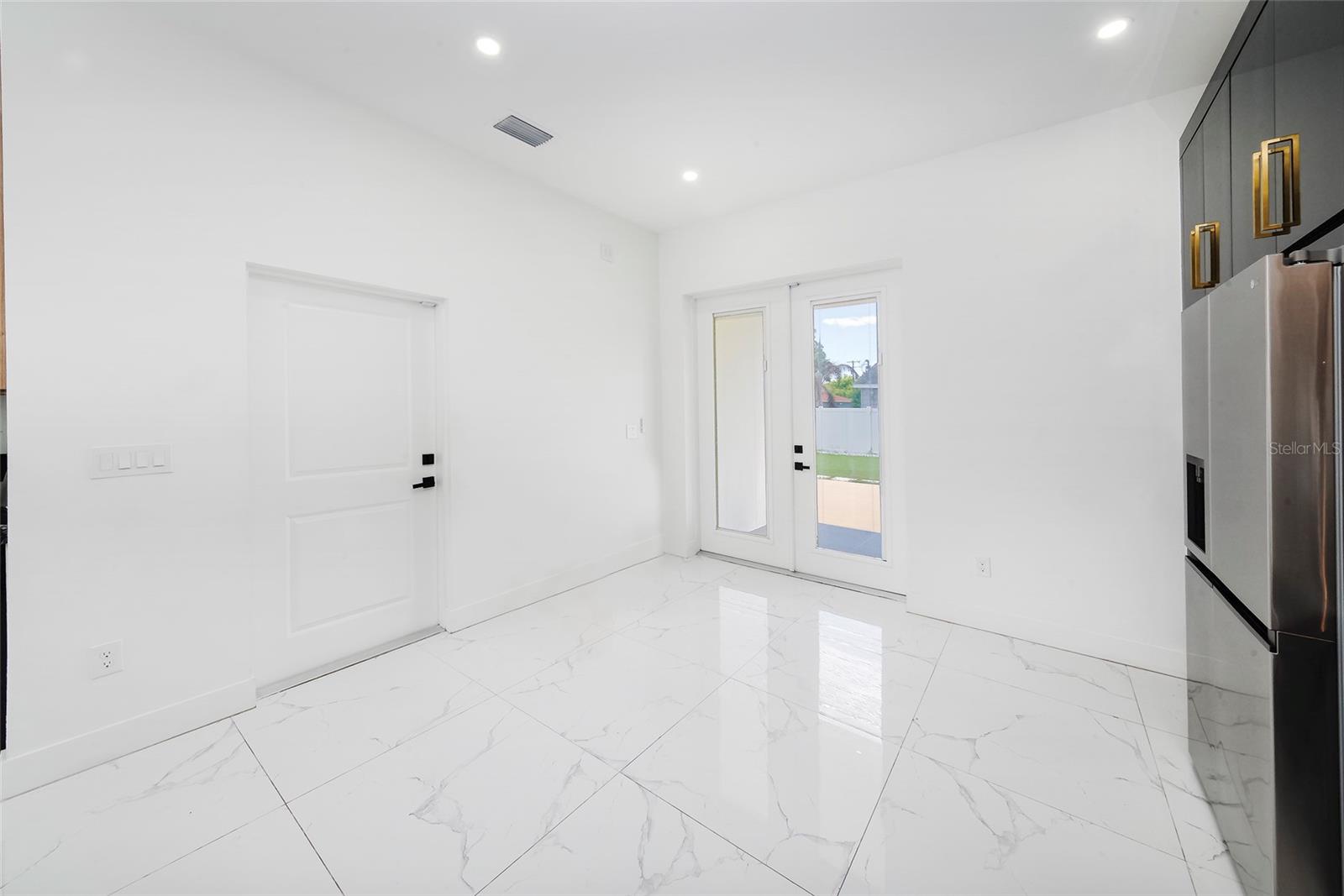 View from Kitchen to Garage Door and Backyard