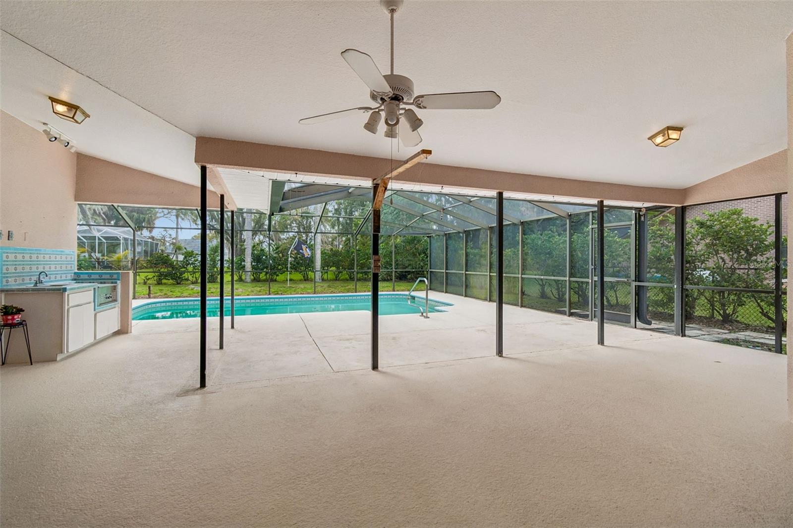 Large pool with a birdcage and lanai