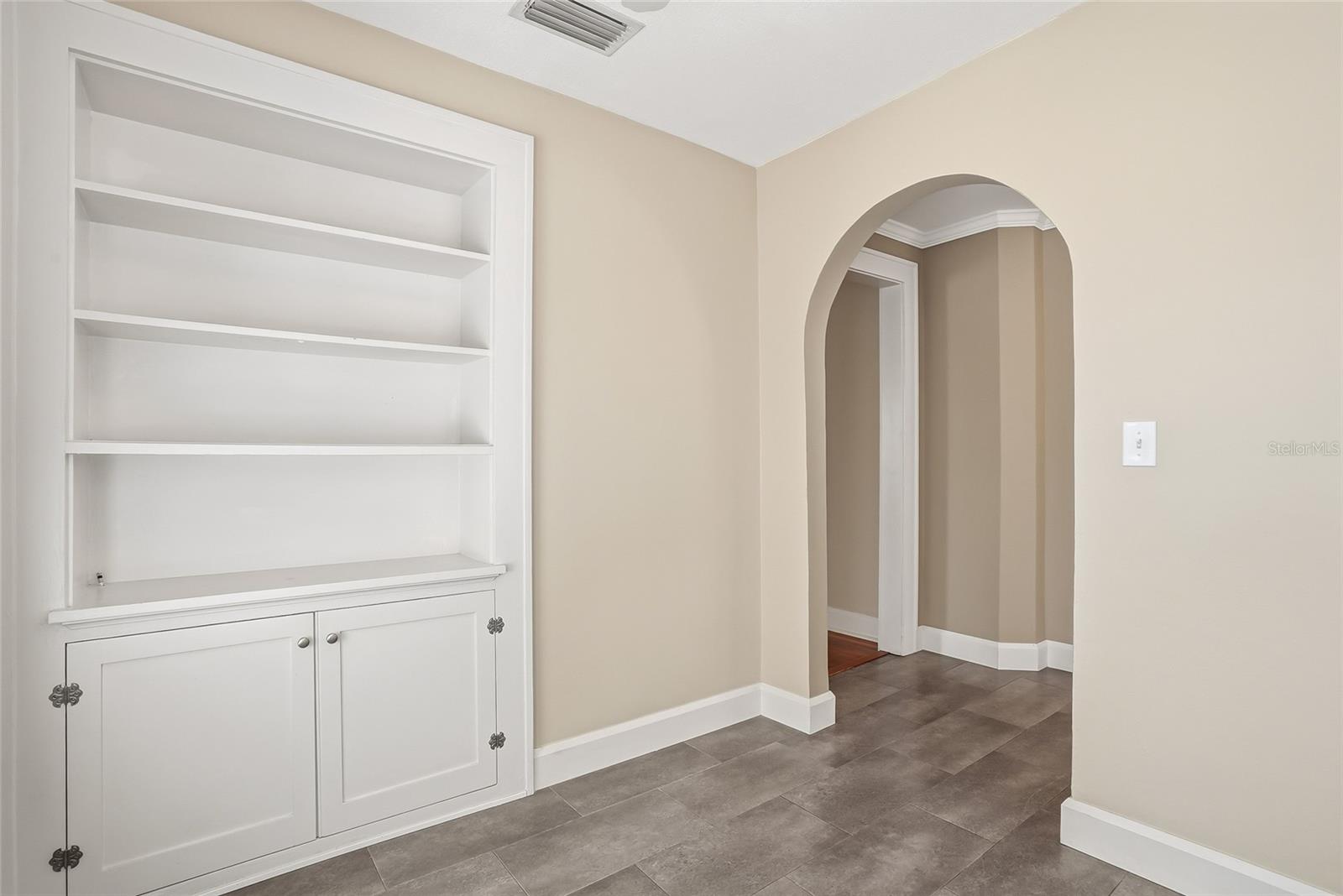 Adjoining breakfast nook or den with built-in shelving.