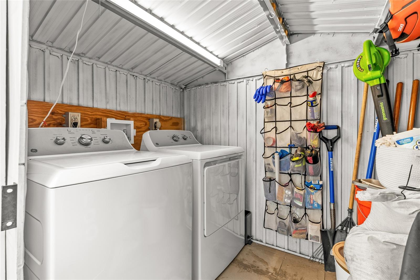 covered washer and dryer in patio shed