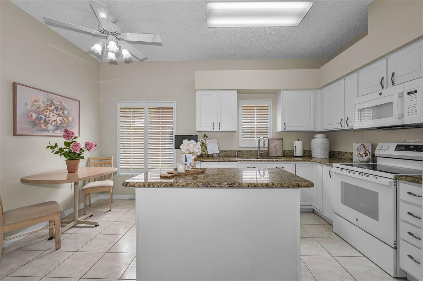 Kitchen boosts a center island with granite countertops