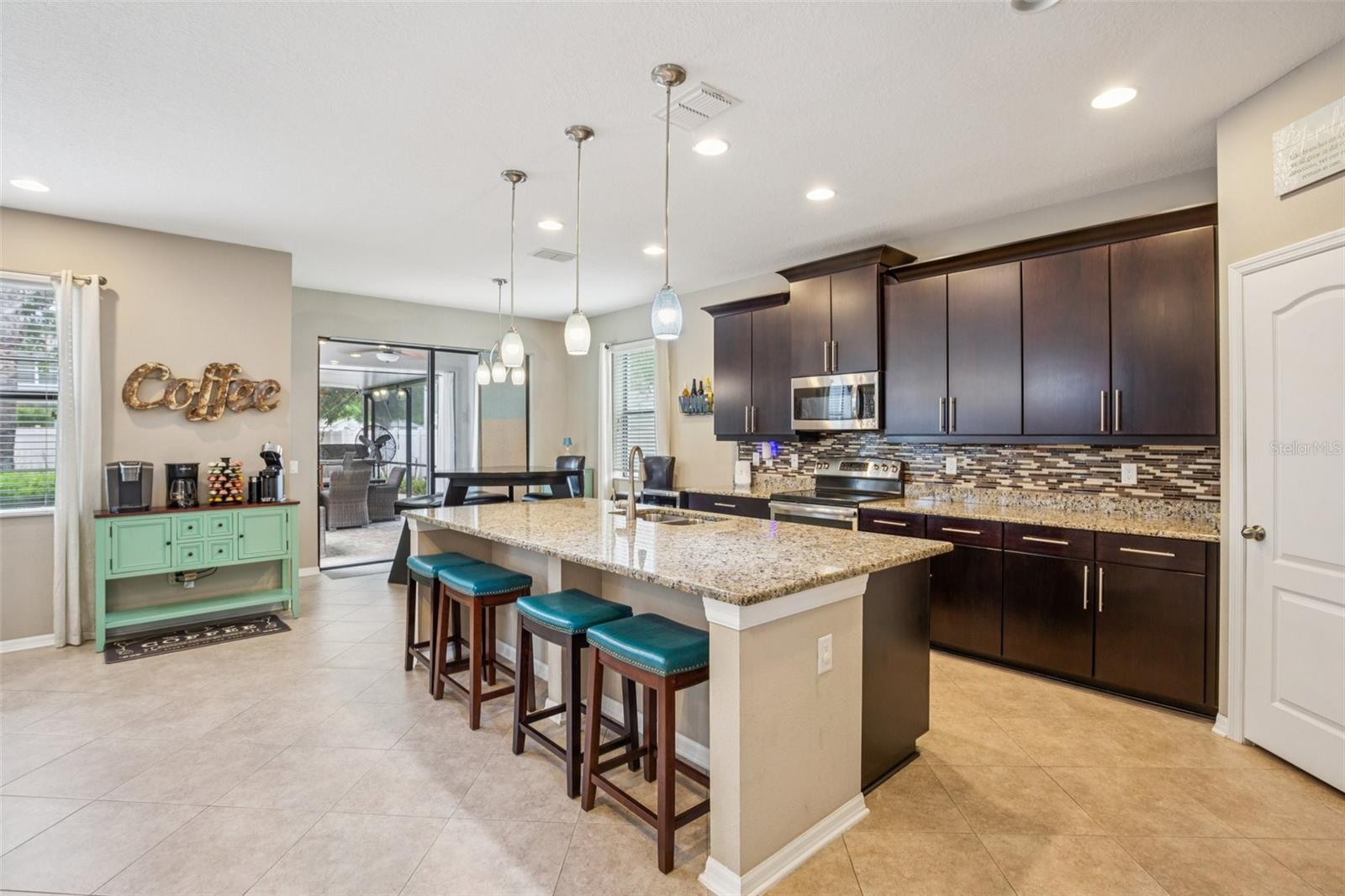 KITCHEN WITH OVER SIZED ISLAND ADDS ADDITIONAL SPACE FOR SEATING AND STORAGE!