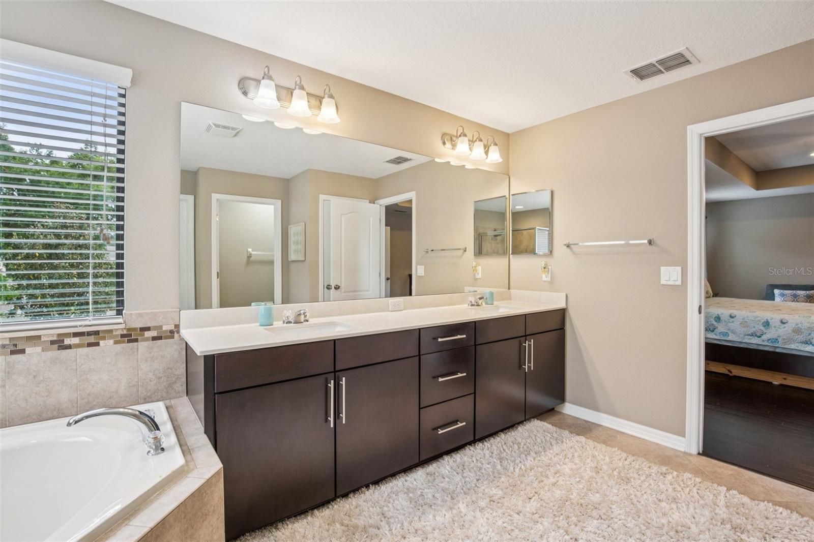 DUAL SINK VANITY IN PRIMARY BATHROOM IS SPACIOUS AND BEAUTIFUL!