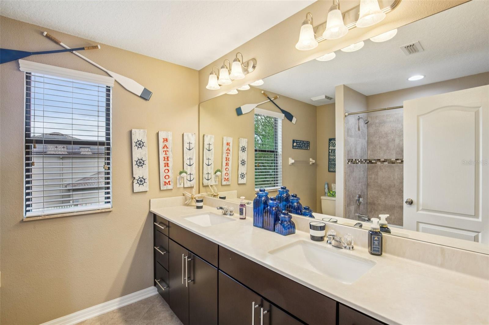 BATHROOM 3 UPSTAIRS HAS DUAL SINK VANITY AND PLENTY OF CABINET STORAGE