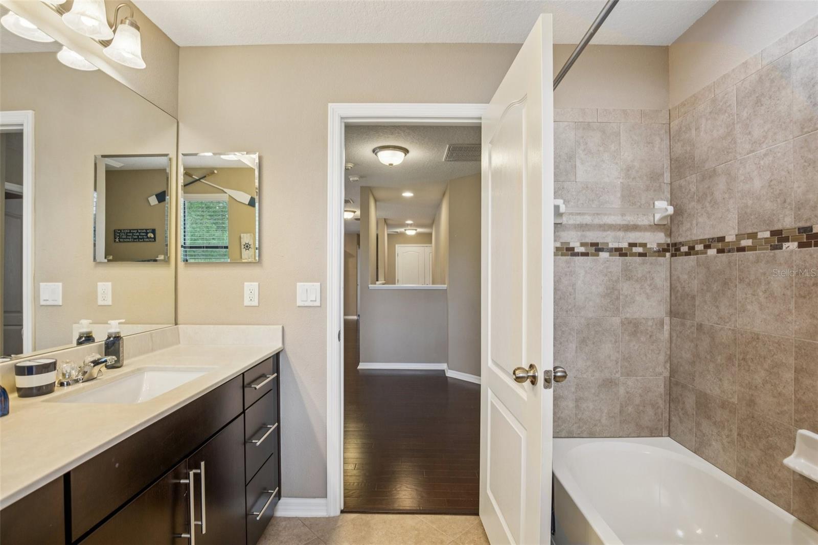 BATHROOM 3 UPSTAIRS HAS DUAL SINK VANITY AND PLENTY OF CABINET STORAGE