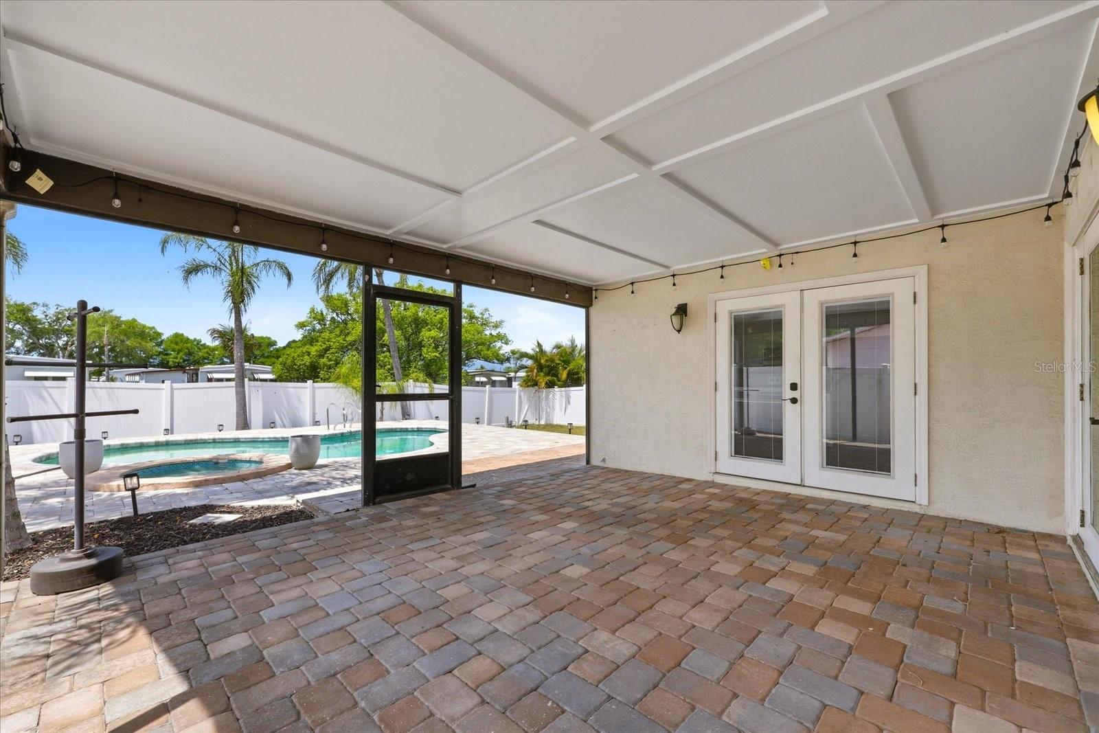 250+ Sq Ft Enclosed Roofed Porch with French Doors to both the Kitchen and the Living Room