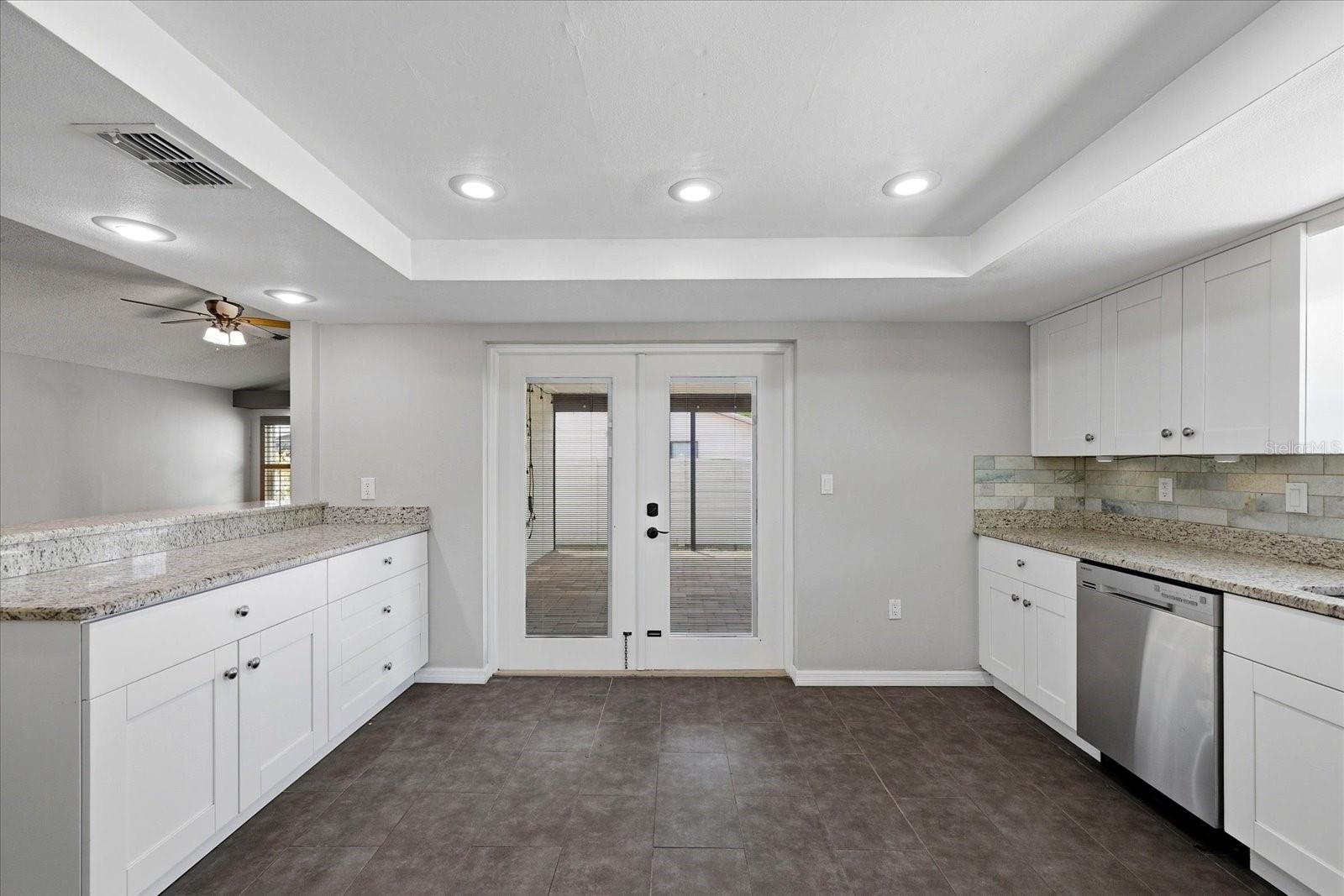 Large Kitchen with Breakfast Bar and French Doors to Enclosed Porch