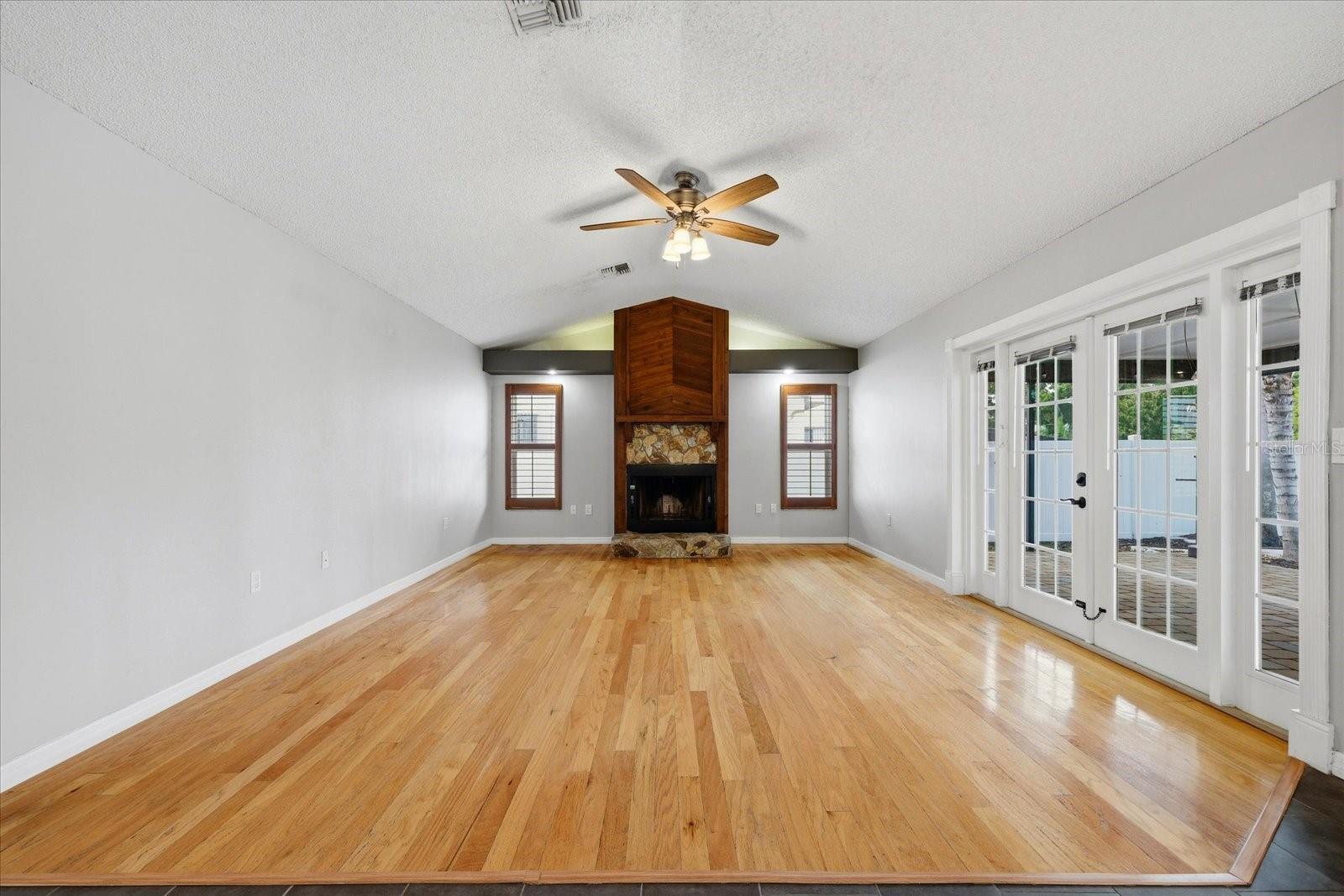 Vaulted Ceilings and Fireplace and French Doors that lead to the Pool