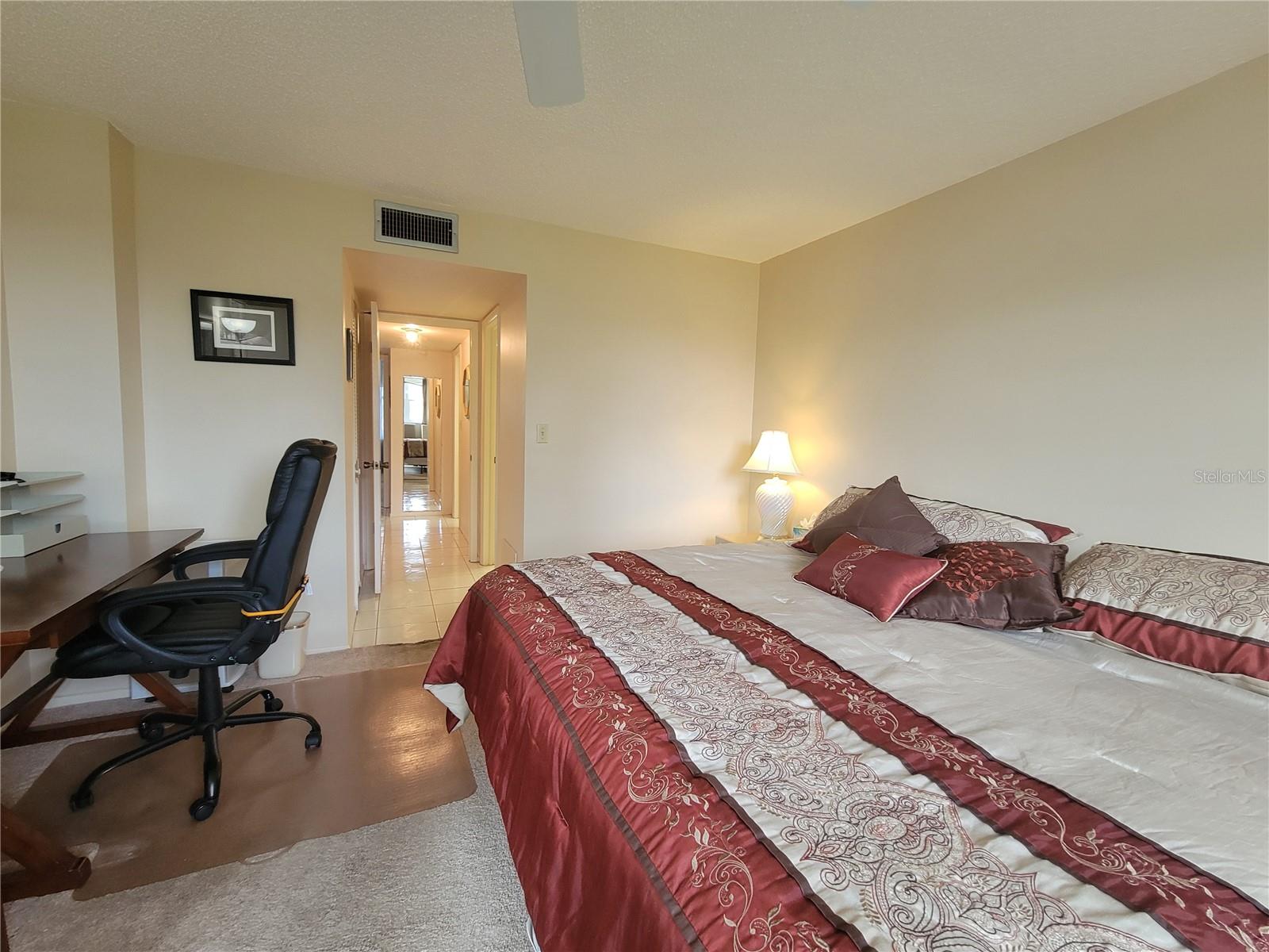 Hallway to walk-in closet and ensuite bathroom