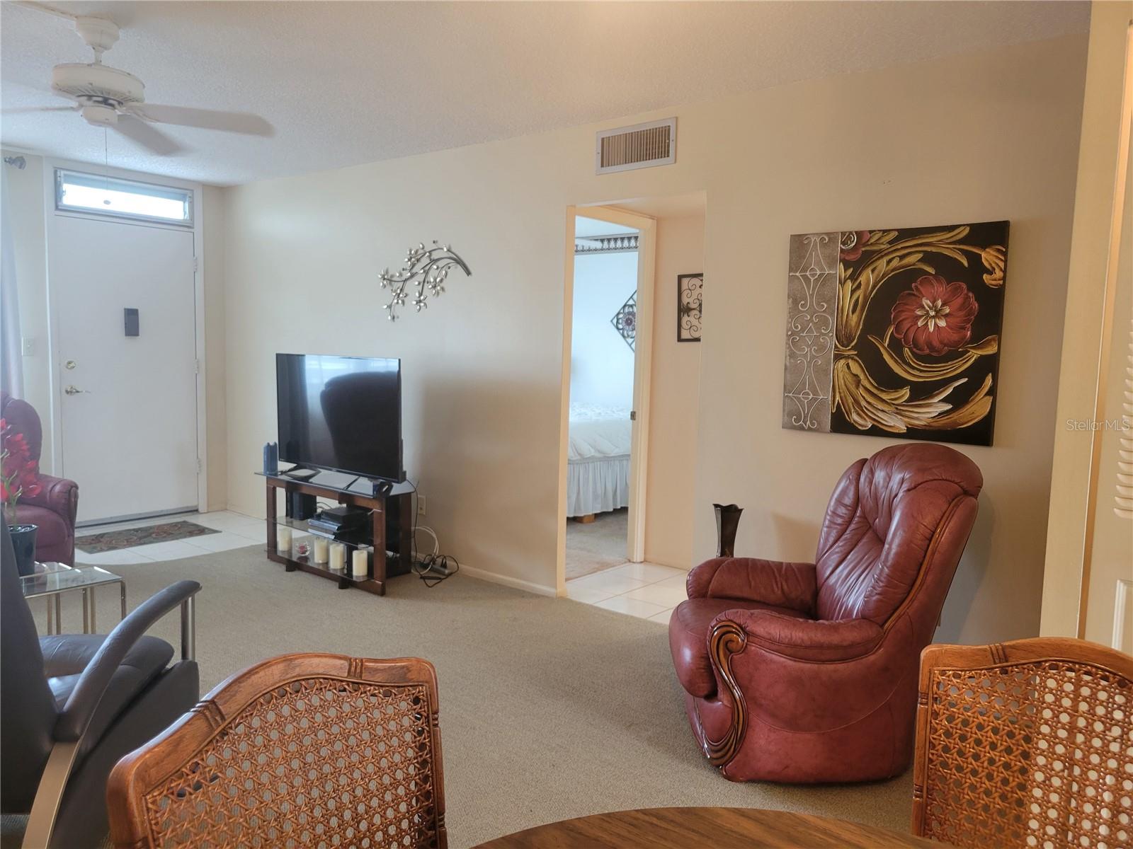 Living/Dining room with guest bedroom in background