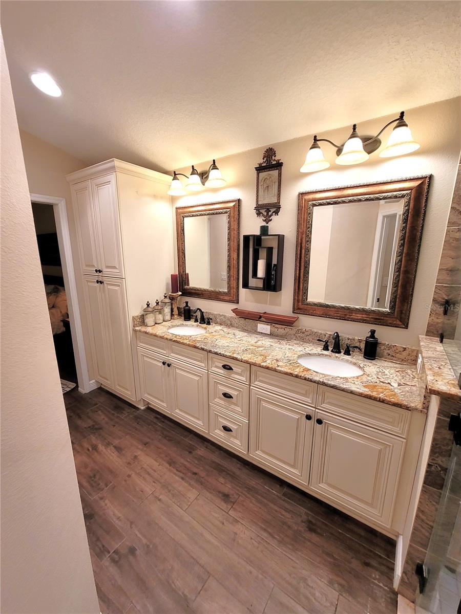 Dual sinks and a ton of storage and linen cabinet.