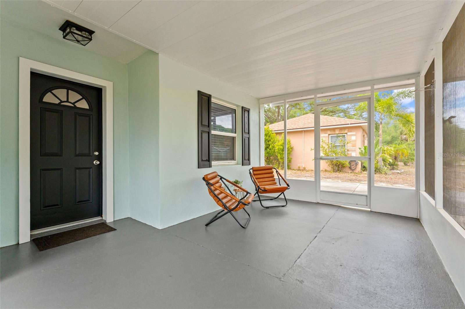 Greet the neighbors from your screened porch as they walk their dogs down this friendly stree