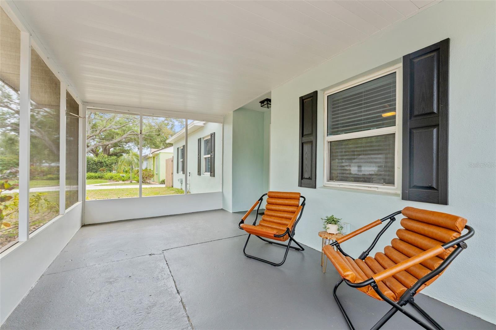 Greet the neighbors from your screened porch as they walk their dogs down this friendly street