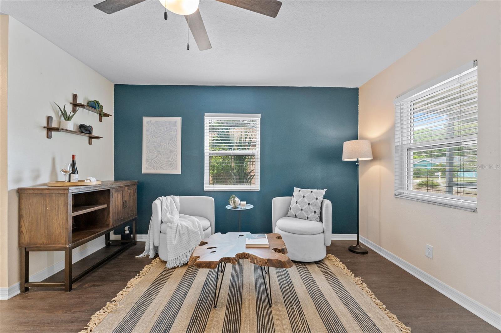 Sitting area or maybe a home office, to the left of the entry.