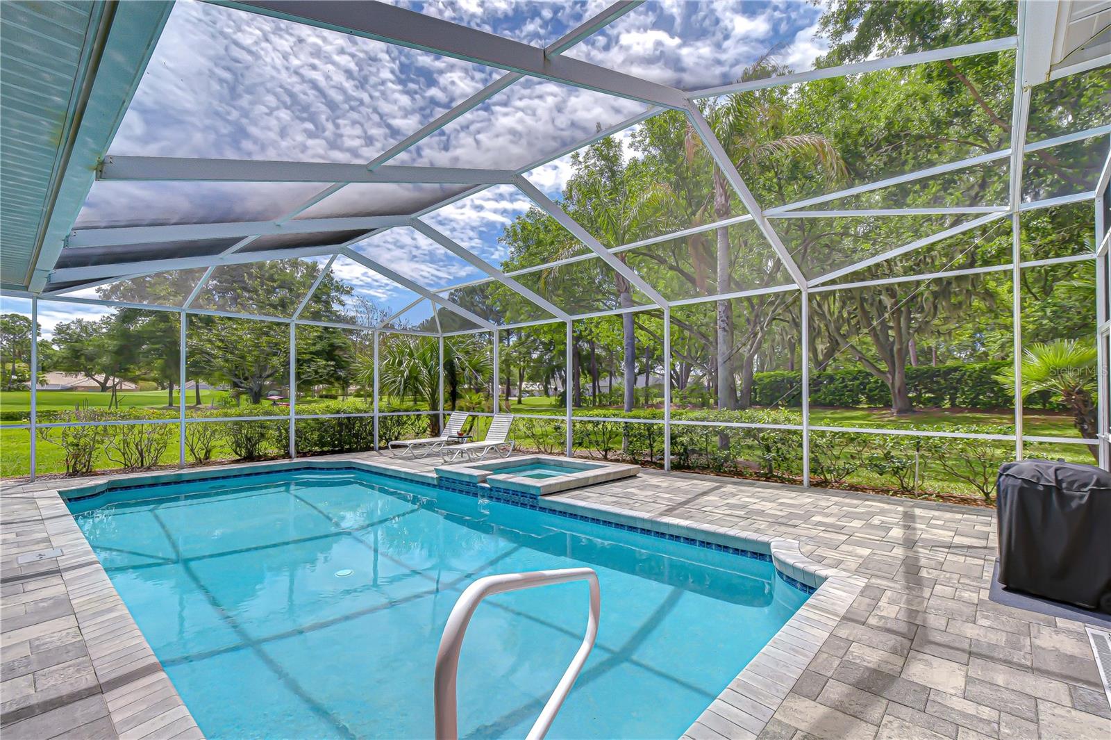 Private pool retreat surrounded by lush landscaping and peaceful views