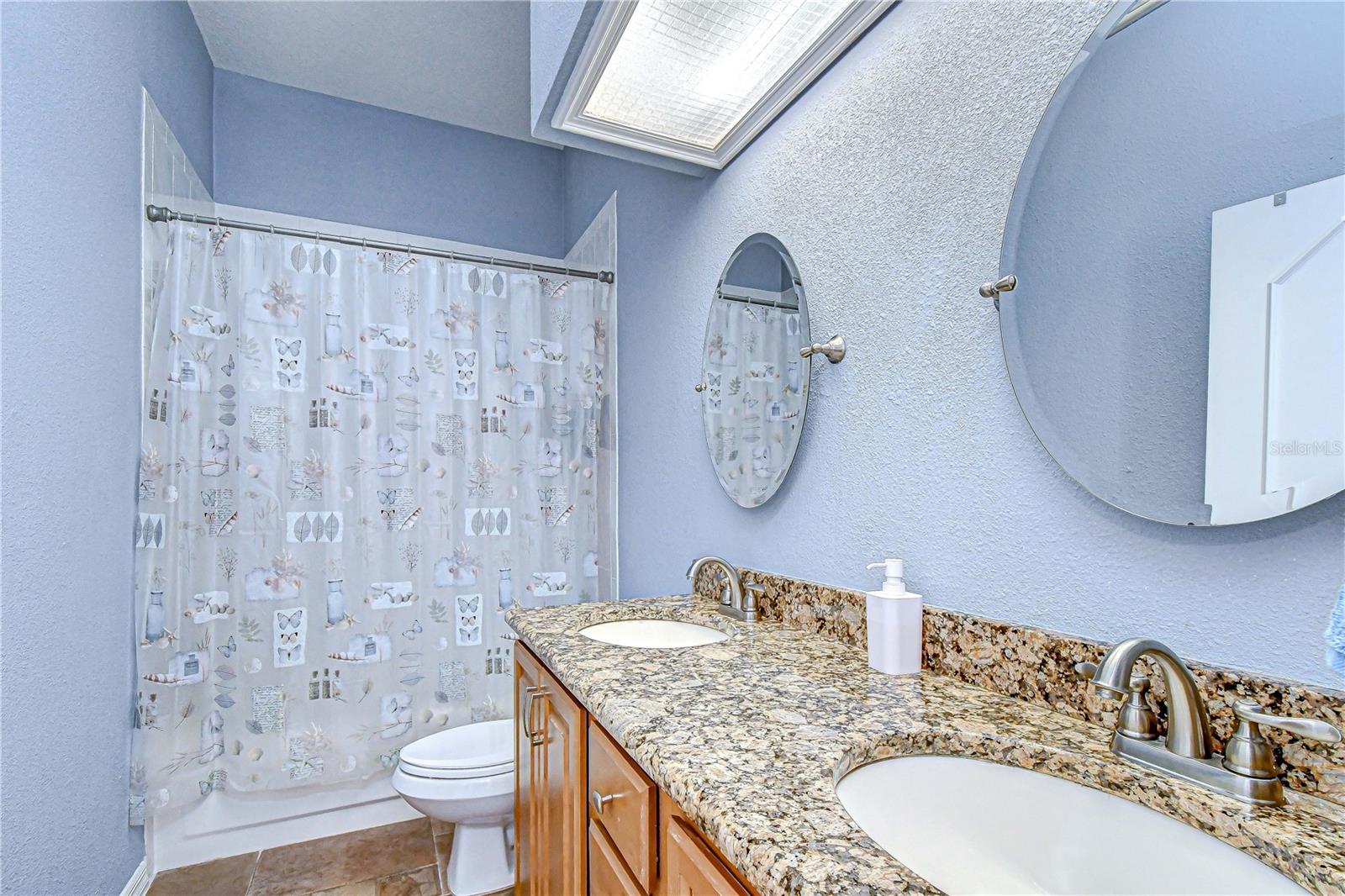 Updated guest bathroom with granite countertops and custom cabinetry