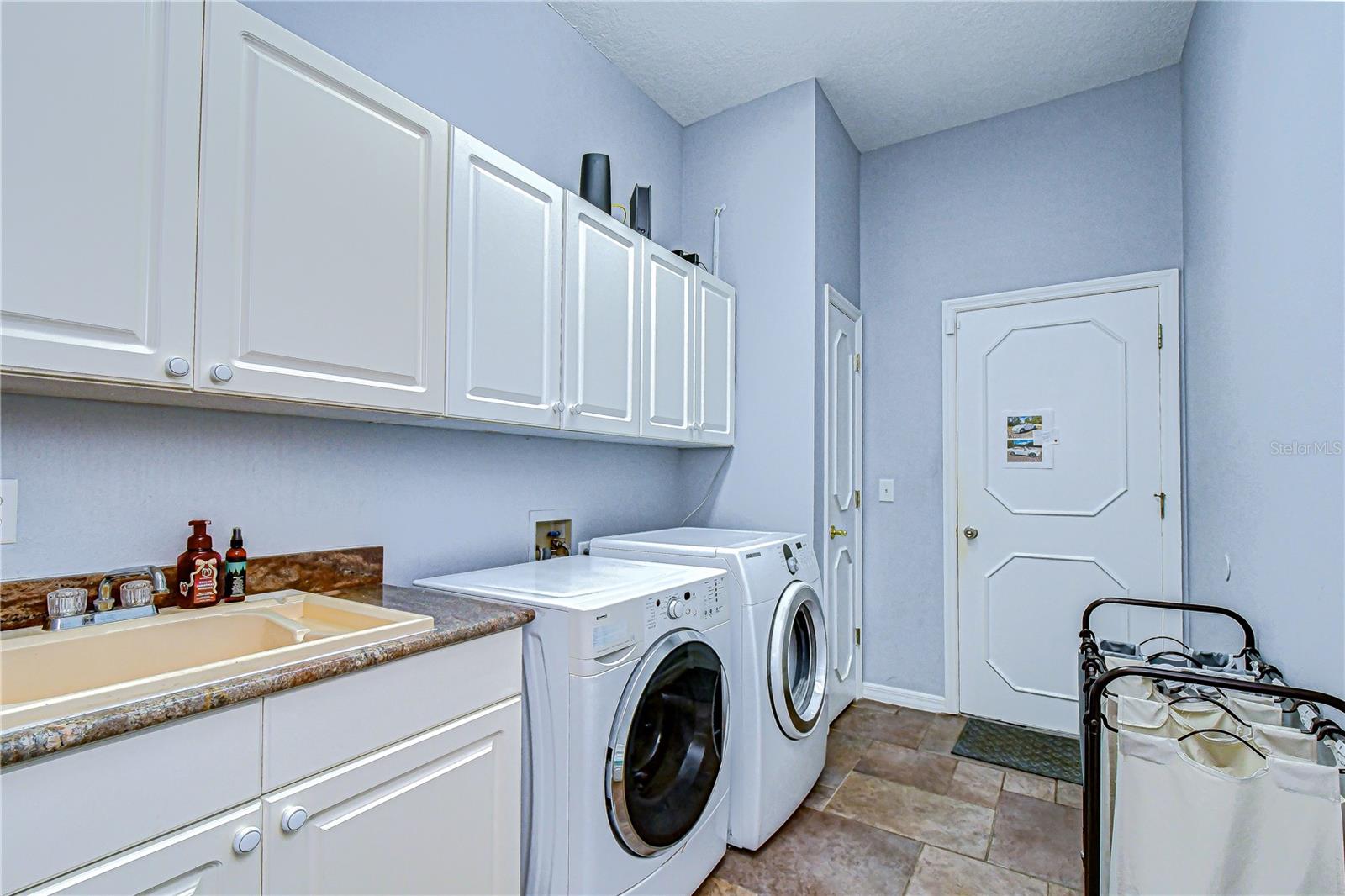Dedicated laundry room with built-in storage and workspace