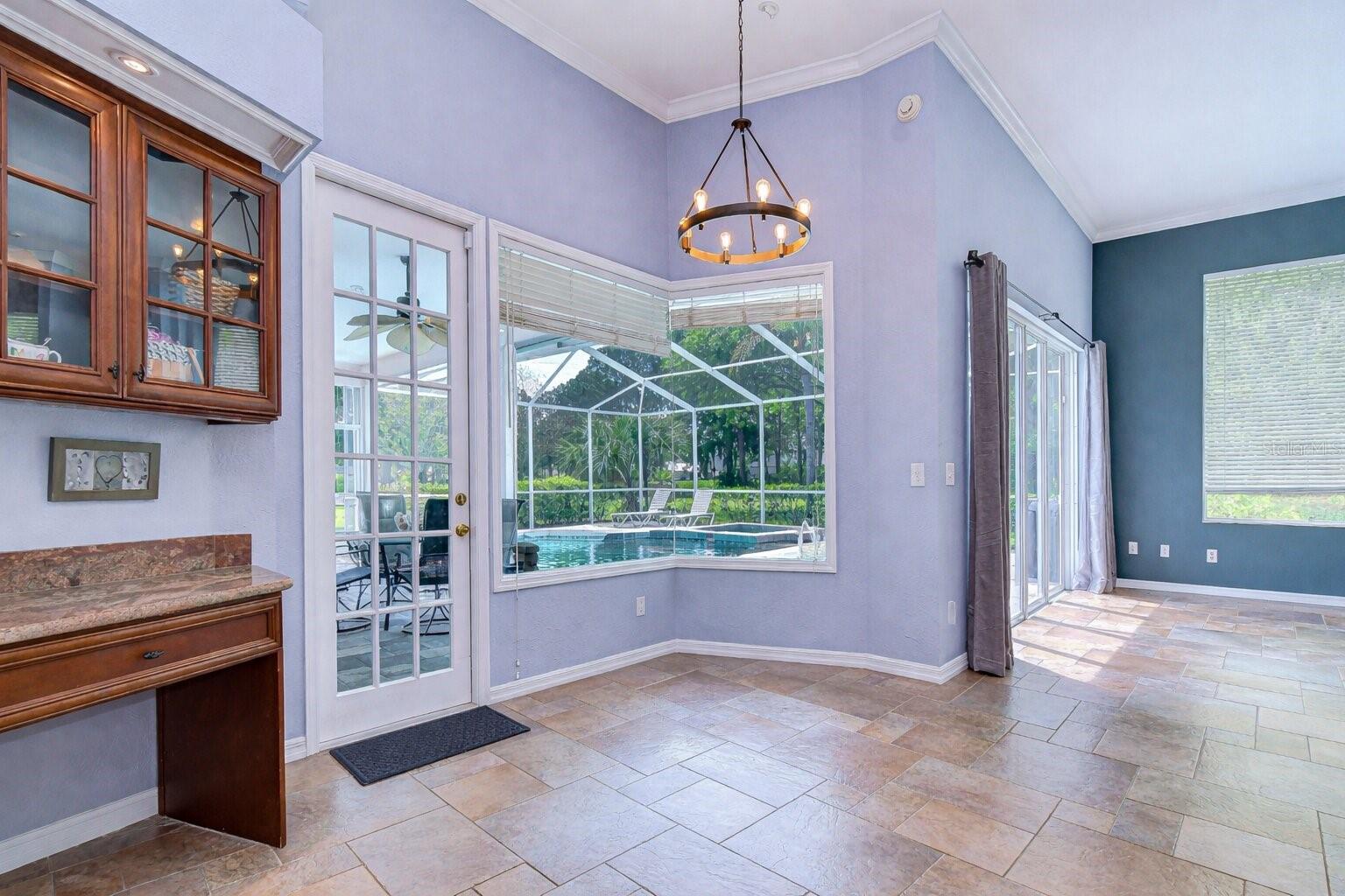 Bright breakfast nook with views of the pool and backyard