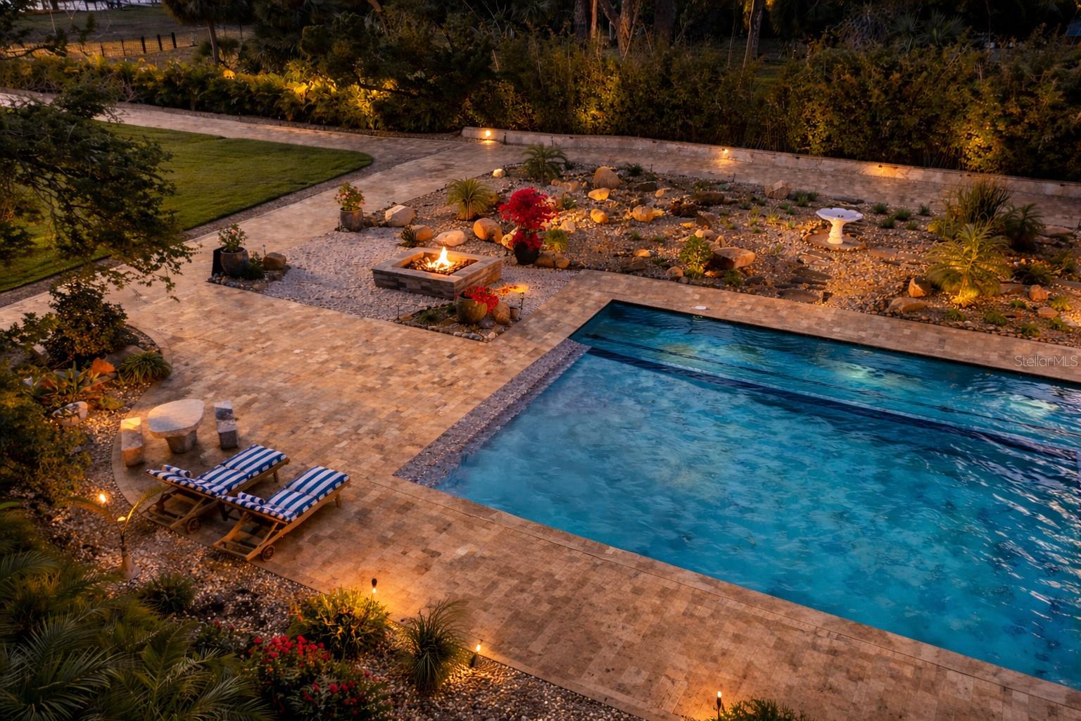 Resort-style pool and spa illuminated for unforgettable evenings under the stars.