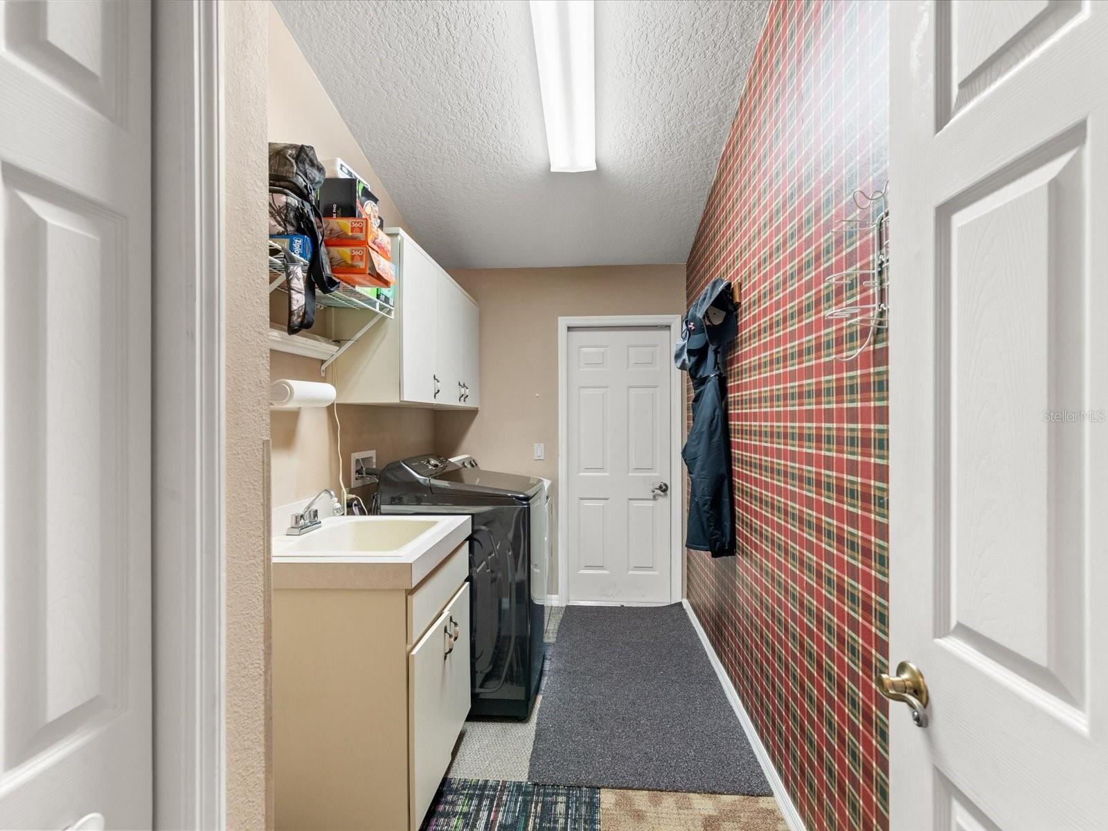 Laundry Room out to garage, next to In-Law suite
