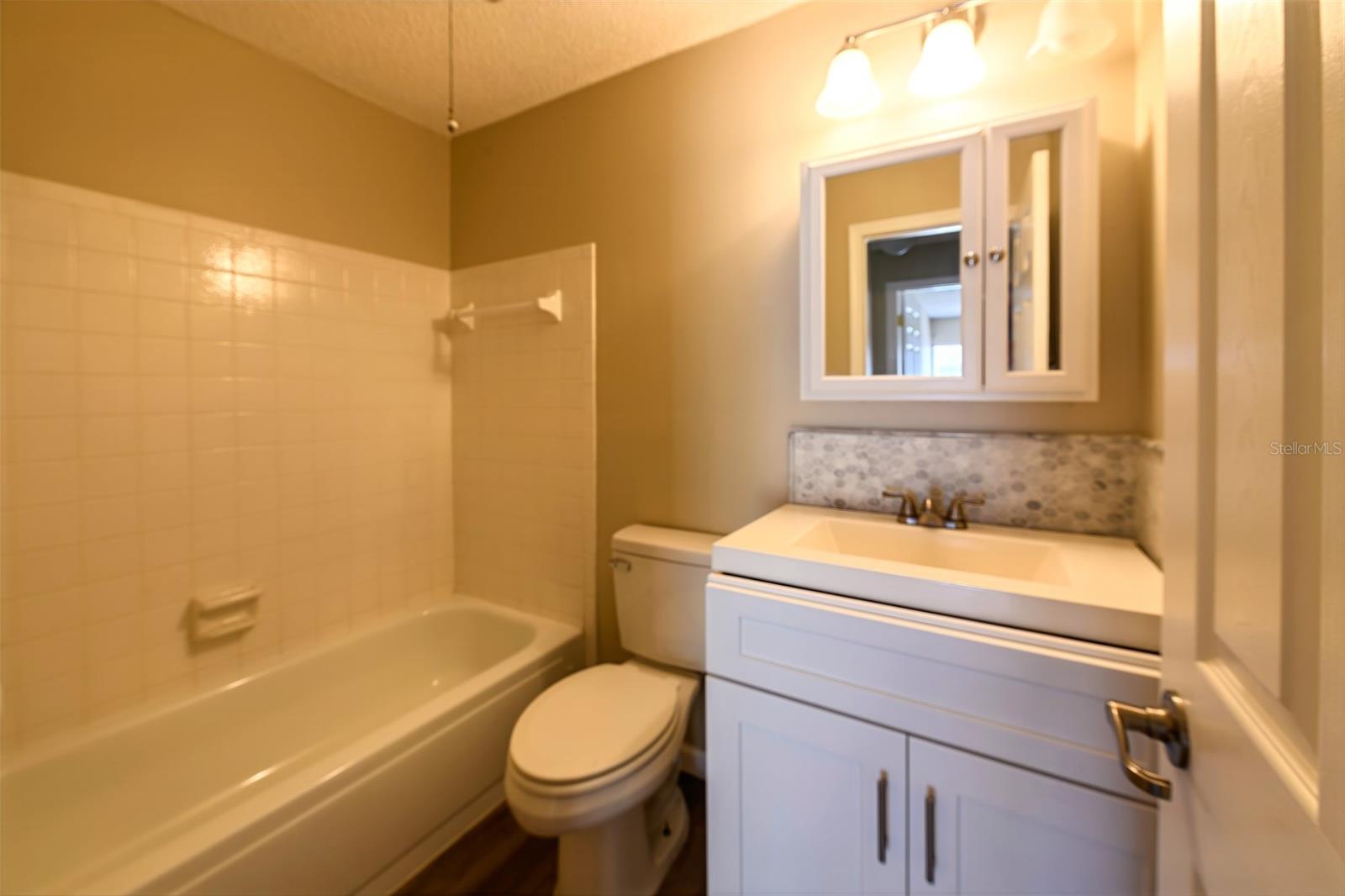 Hall bath with tub & shower.