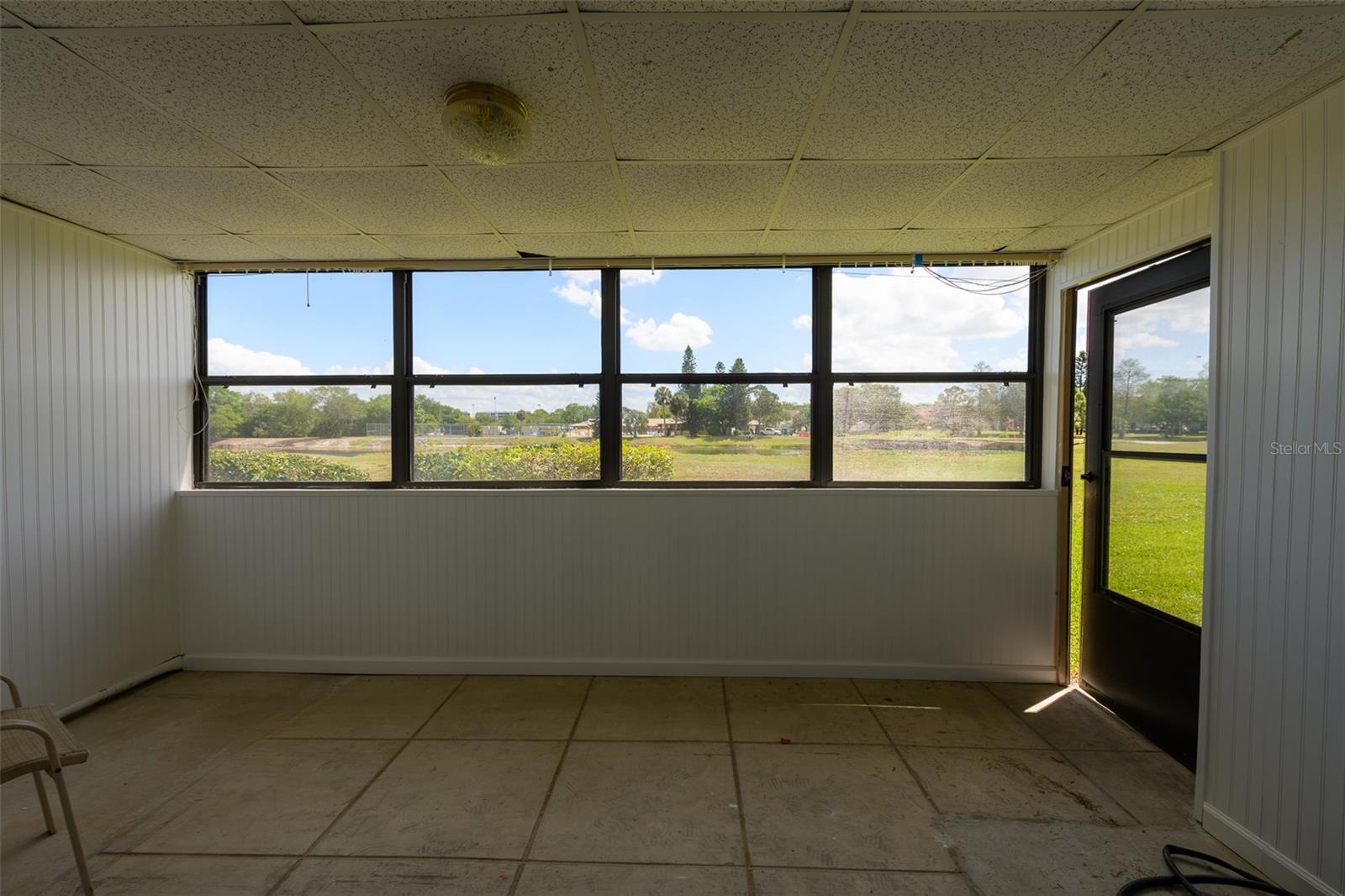 Enclosed porc with back door to green space/pond.