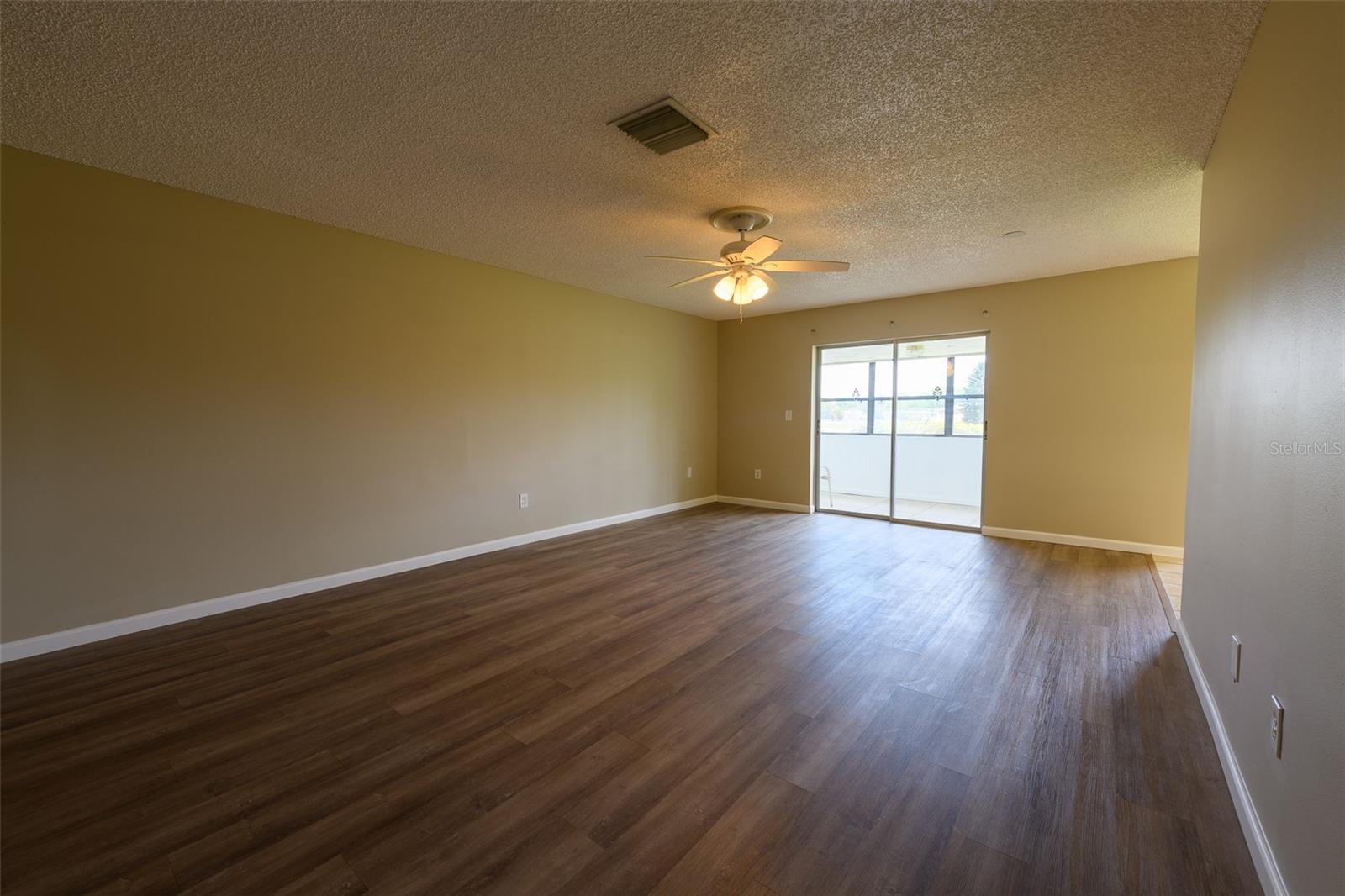 Living room leading to enclosed porch.