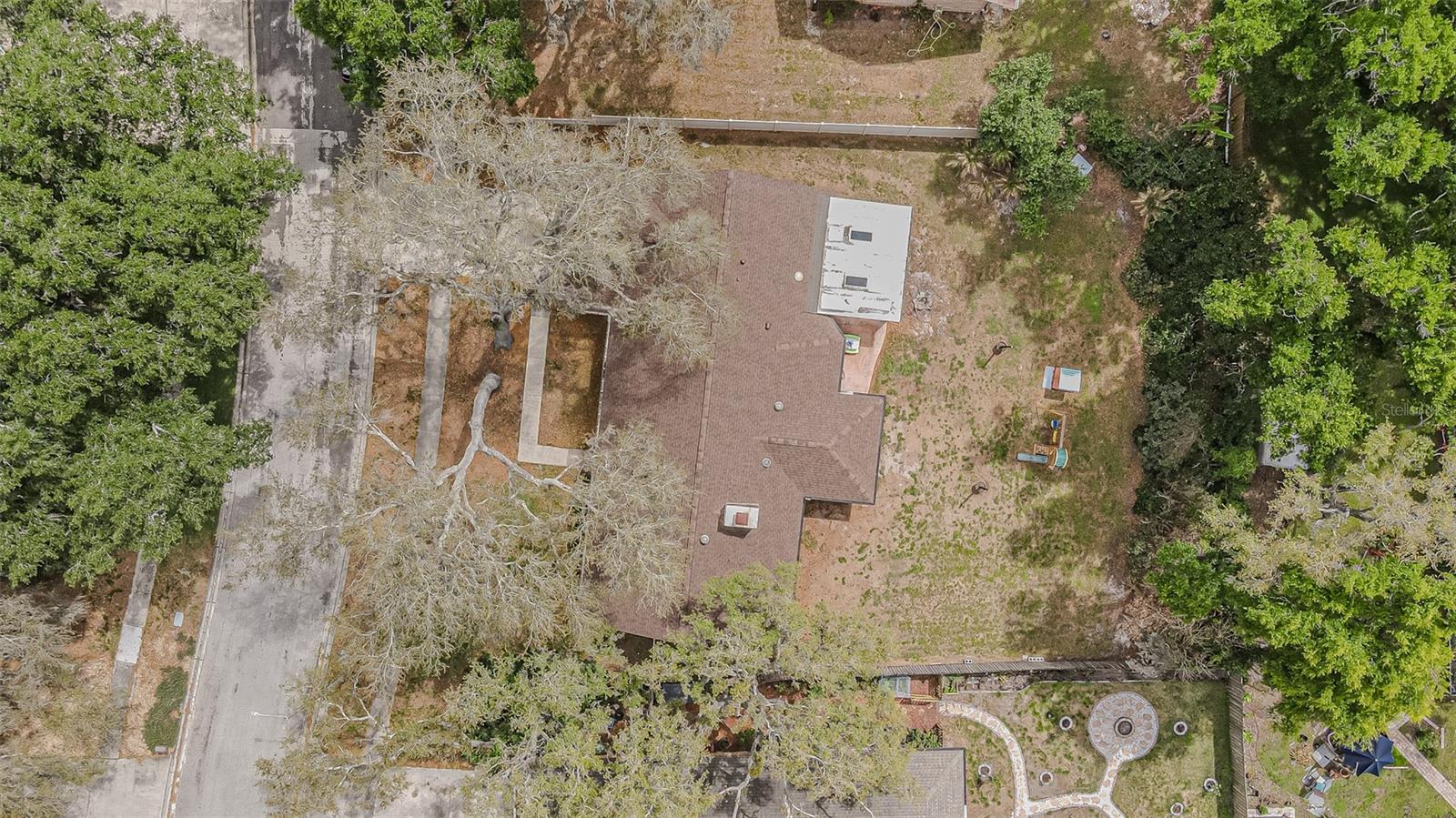 Private backyard with mature landscaping along the fence line.
