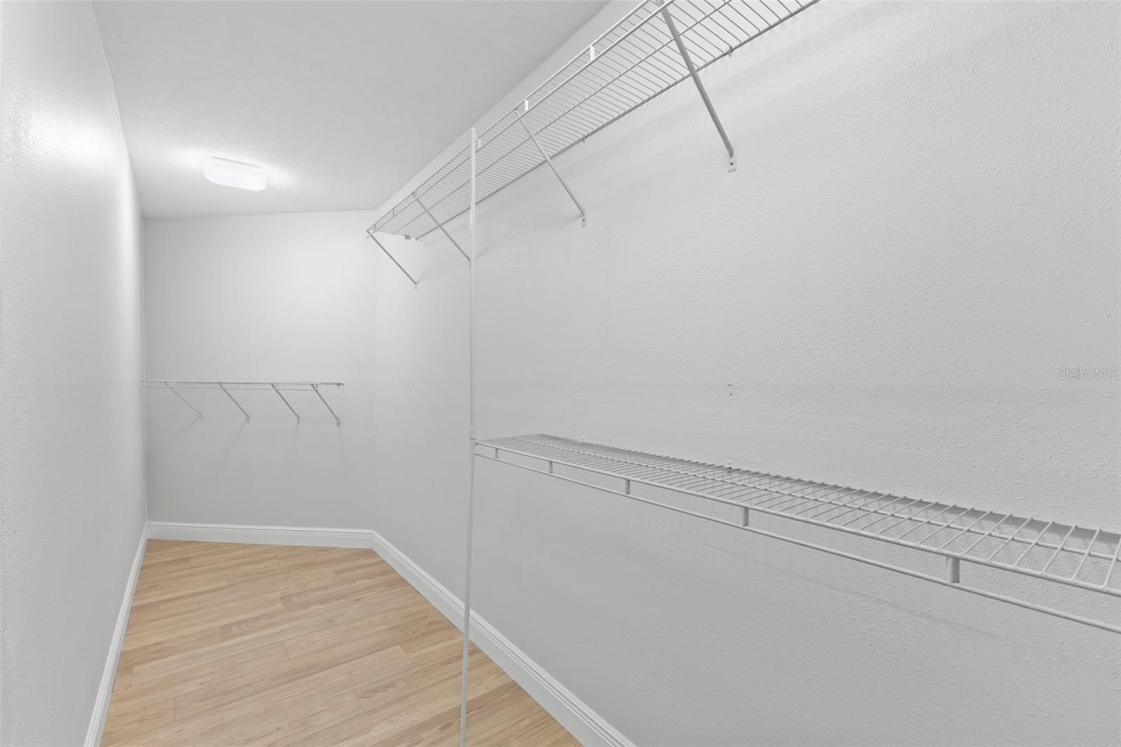 Primary bedroom walk in closet