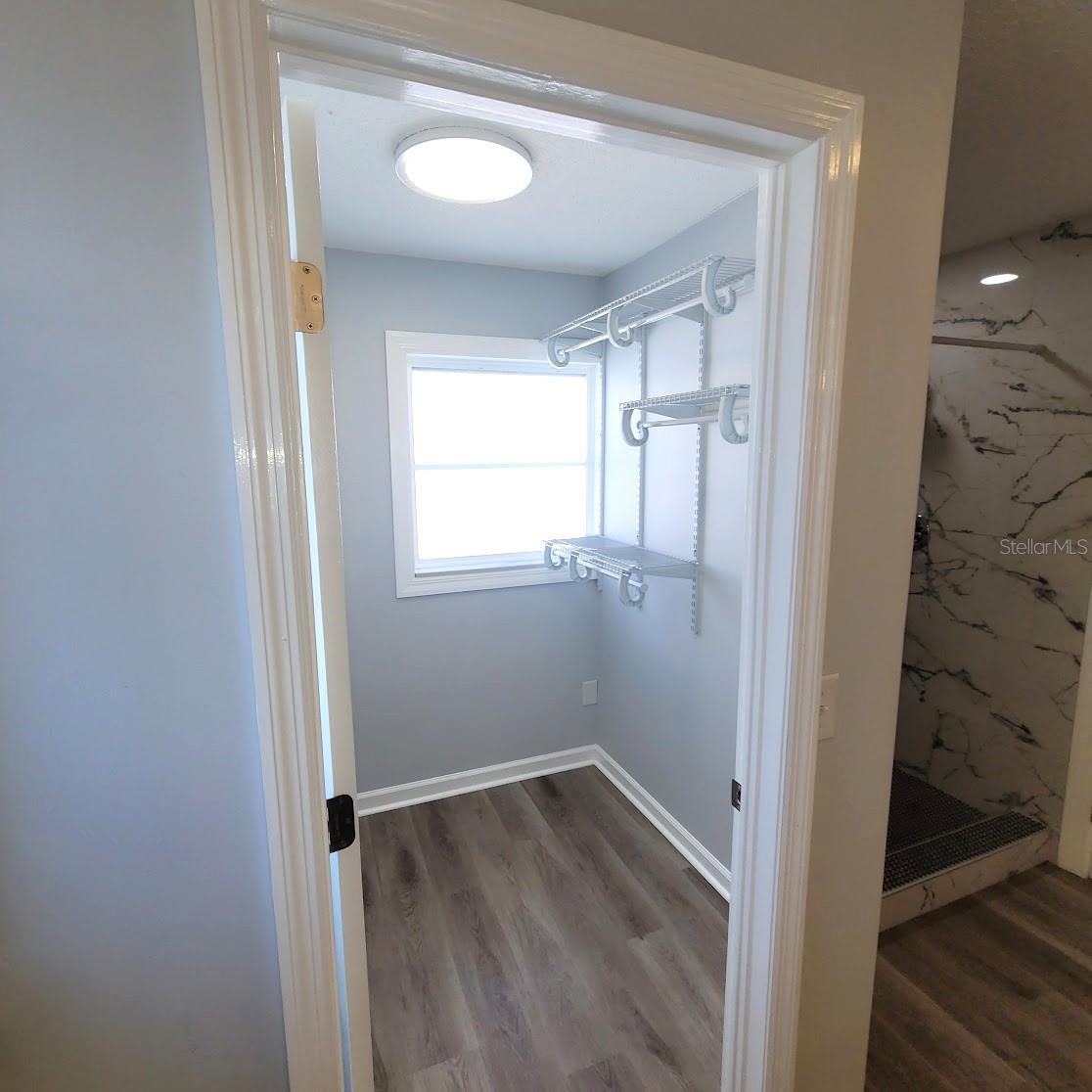 Primary bathroom area has a walk in closet.