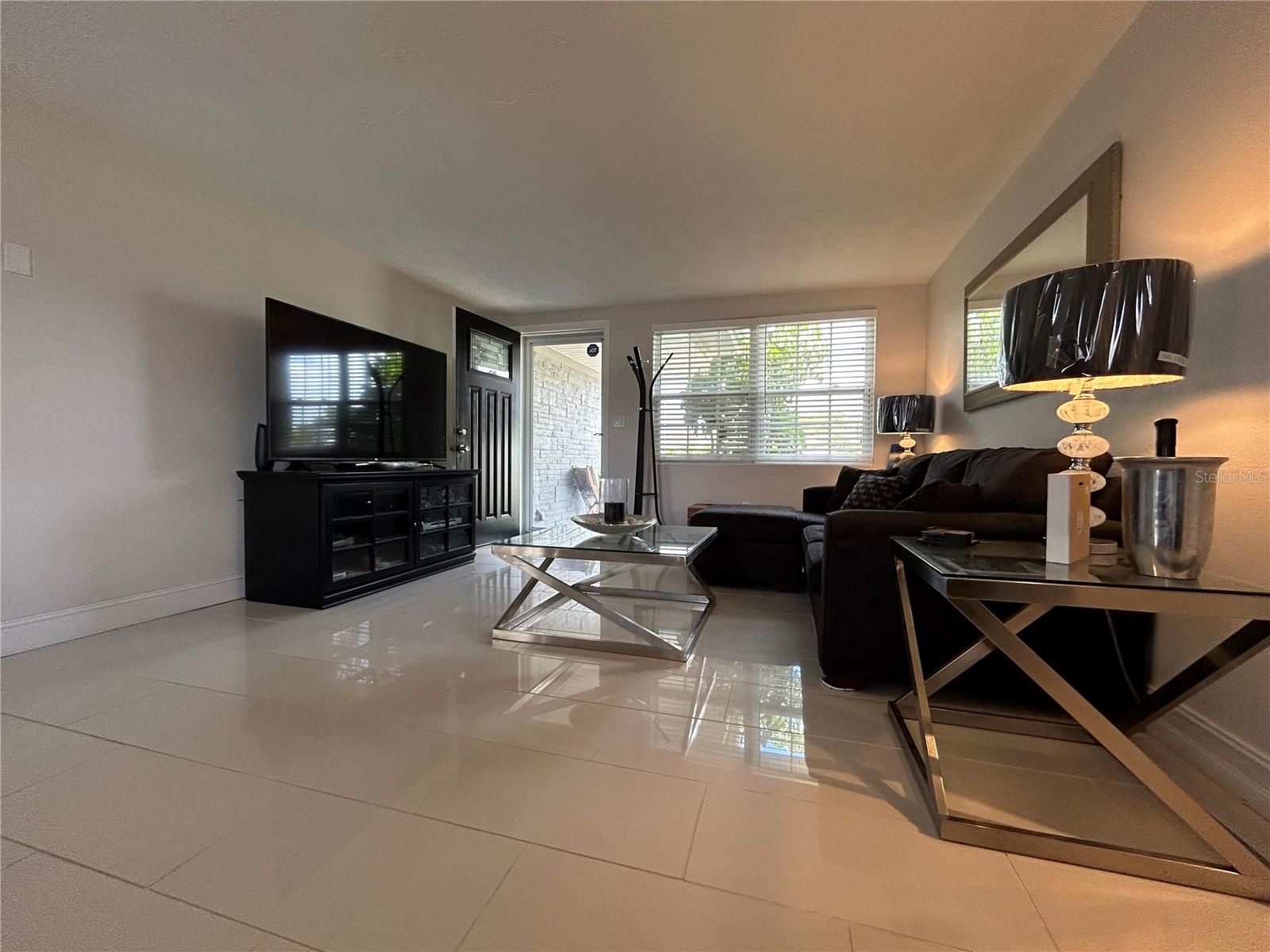 Designer space with glossy white tiled floors.